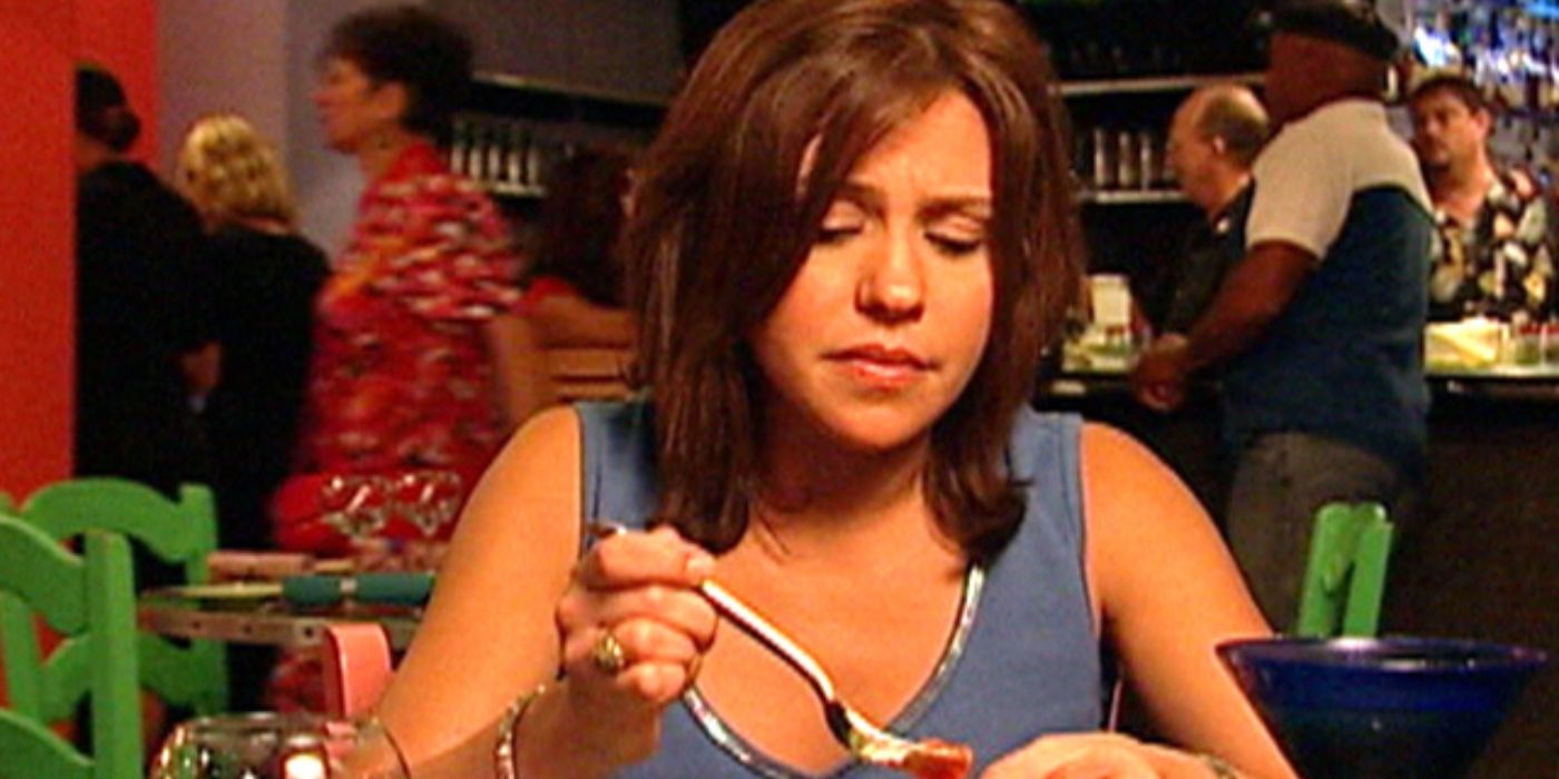 Rachael Ray eats food with a skeptical look on her face during an episode of $40 a Day.