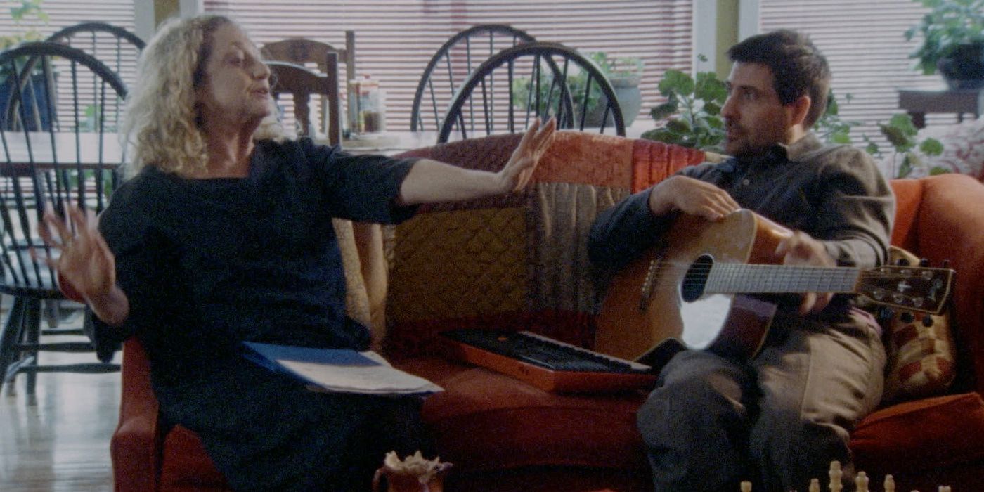 Jason Schwartzman and Carol Kane sit on a couch in Between the Temples.