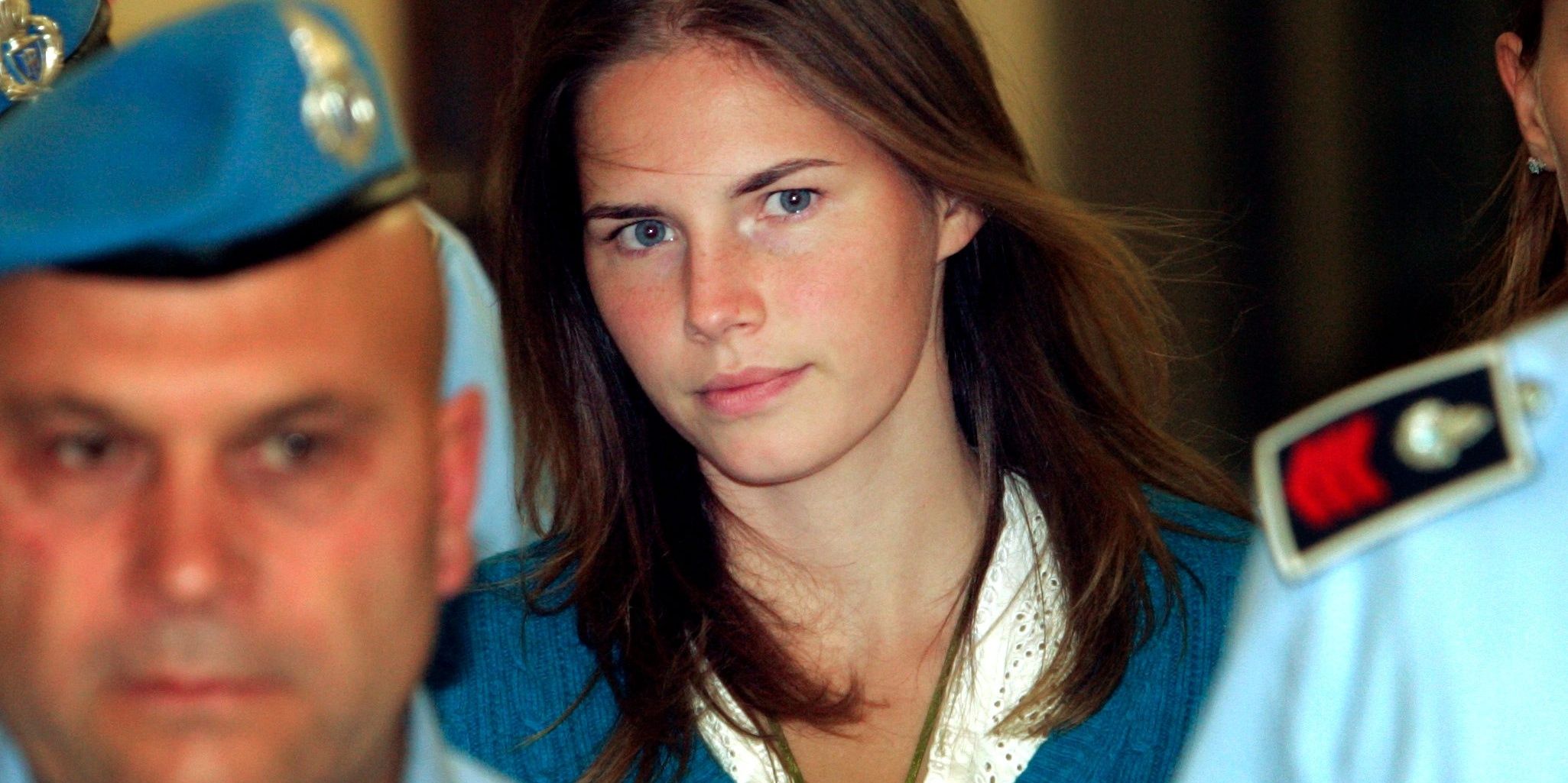 Amanda Knox walks surrounded by police officers in footage shown in Amanda Knox