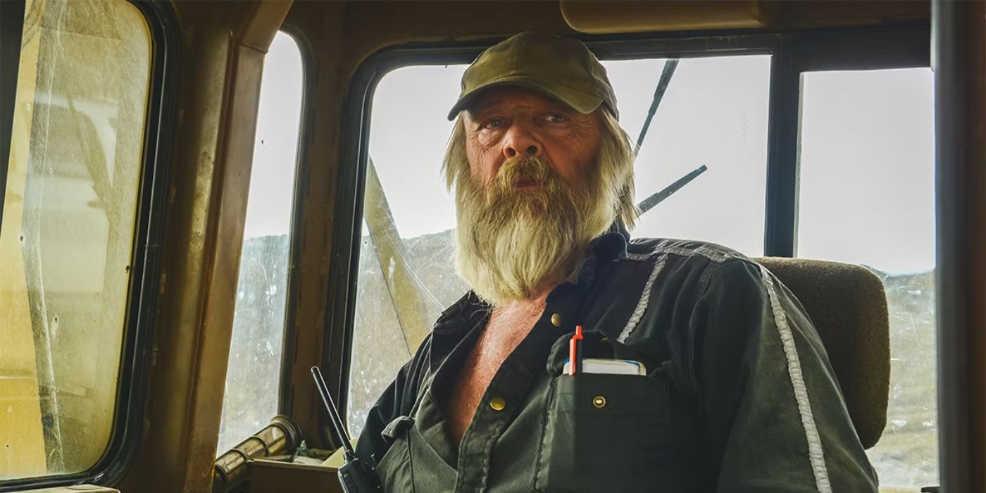 A Gold Rush cast member sitting in a piece of mining equipment