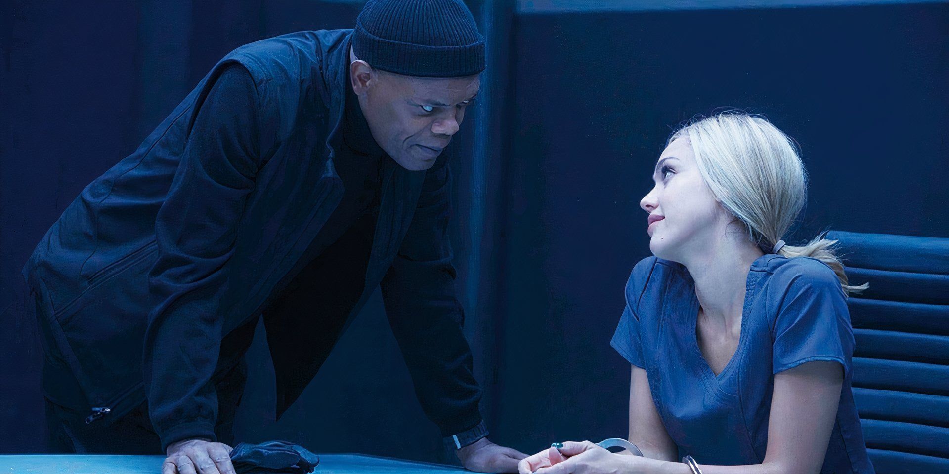 Hardman in the middle of interrogating a young, blonde woman handcuffed to the table in &lsquo;Barely Lethal&rsquo; (2015)
