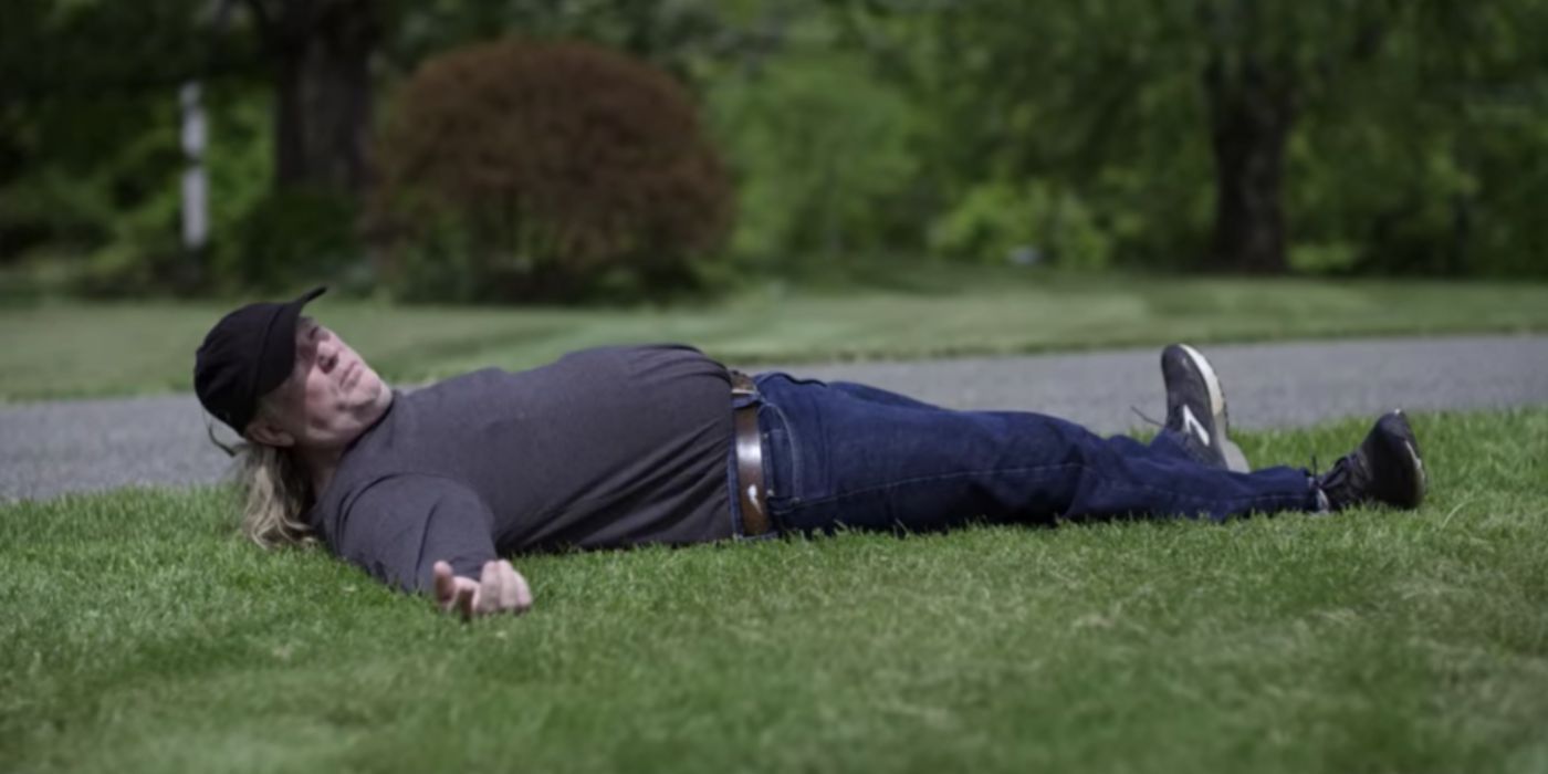 Thom Reed lays on the ground, demonstrating how he was abducted, on 'Unsolved Mysteries' 