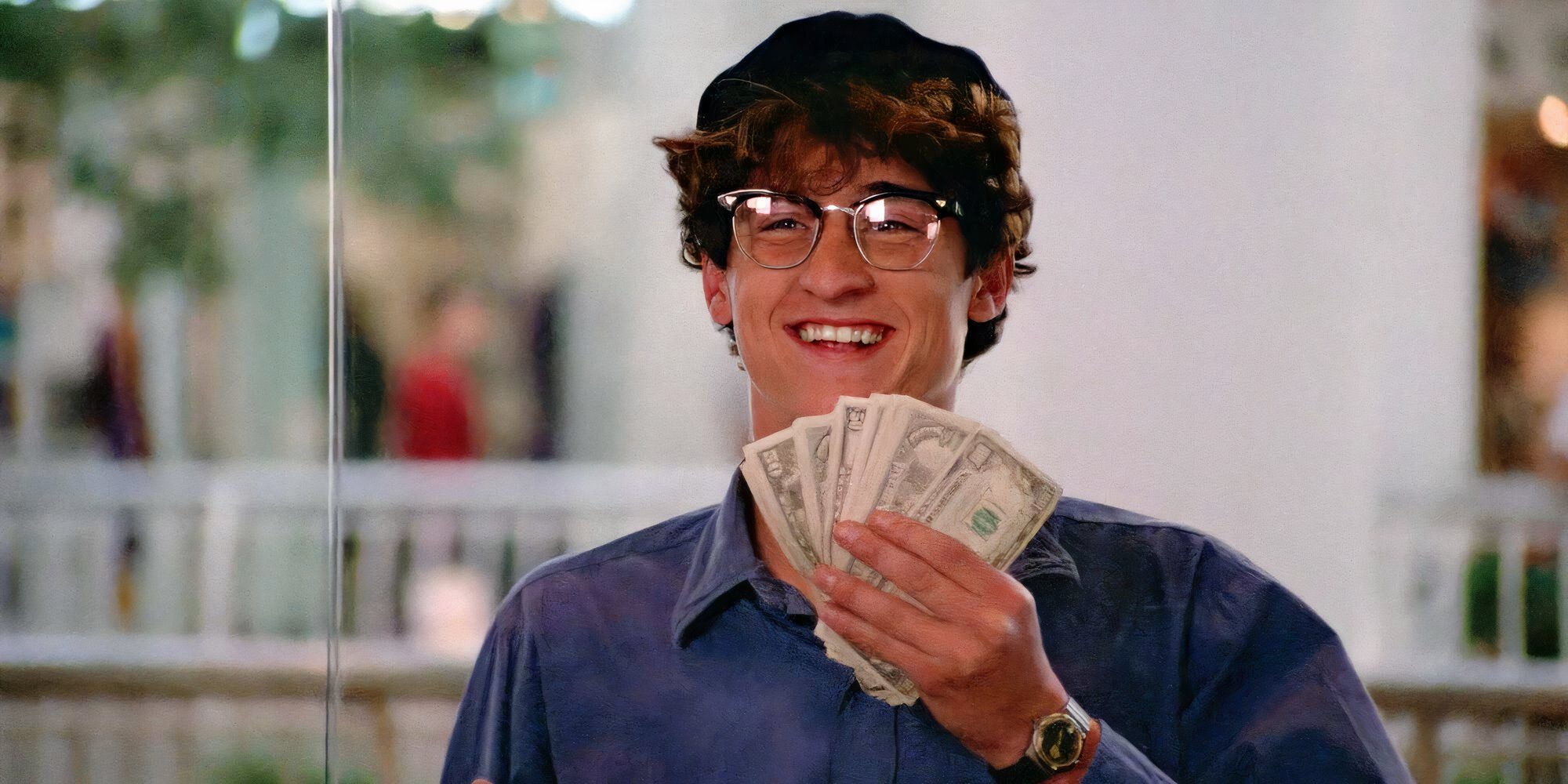 Patrick Dempsey as Ronald Miller holding up a stack of cash in 'Can't Buy Me Love' (1987)