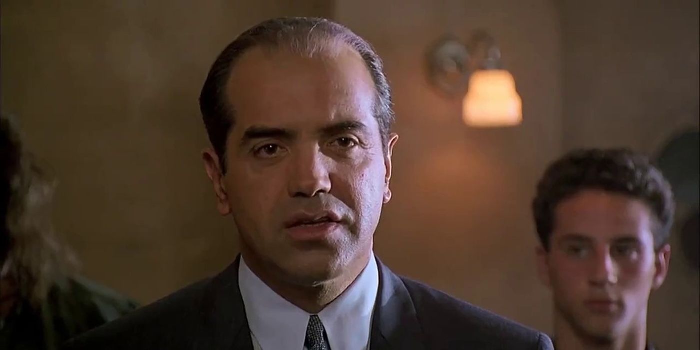 Chase Palminteri in a suit with slicked back hair looking serious in A Bronx Tale