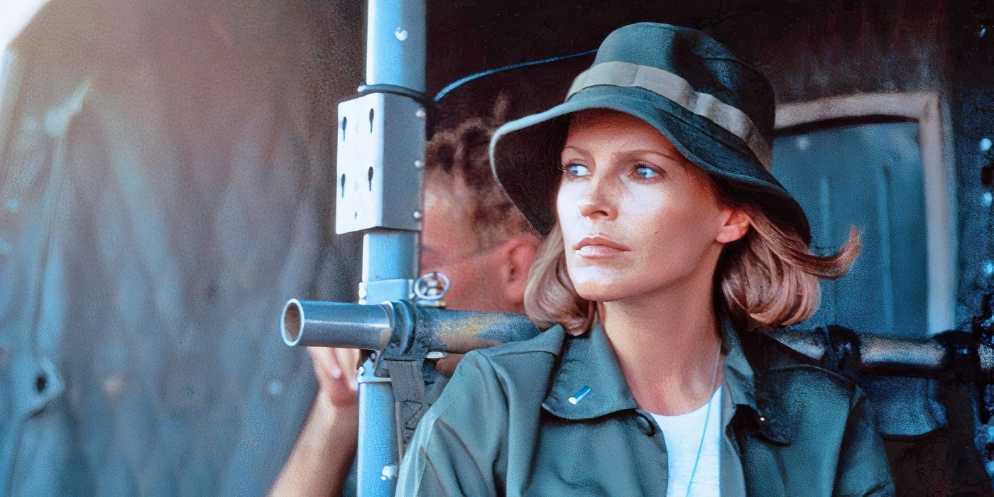 A blonde woman wearing military green looks off in the distance in Purple Hearts (1984)