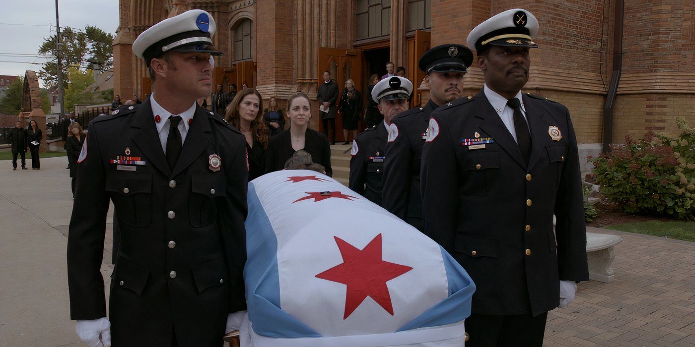 Taylor Kinney as Kelly Severide and Eamonn Walker as Chief Boden holding a casket in Chicago Fire.