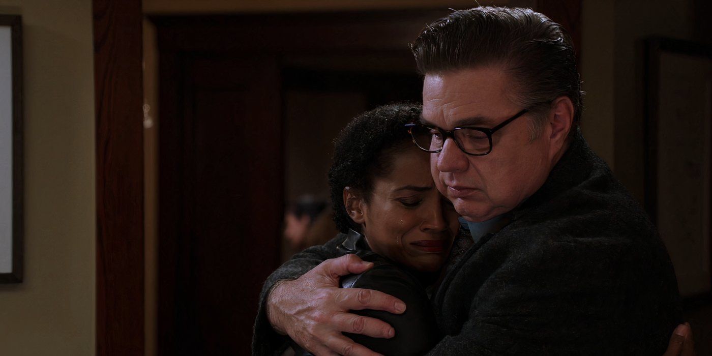 Oliver Platt as Dr. Daniel Charles hugging Mekia Cox as Robin Charles in Chicago Med.