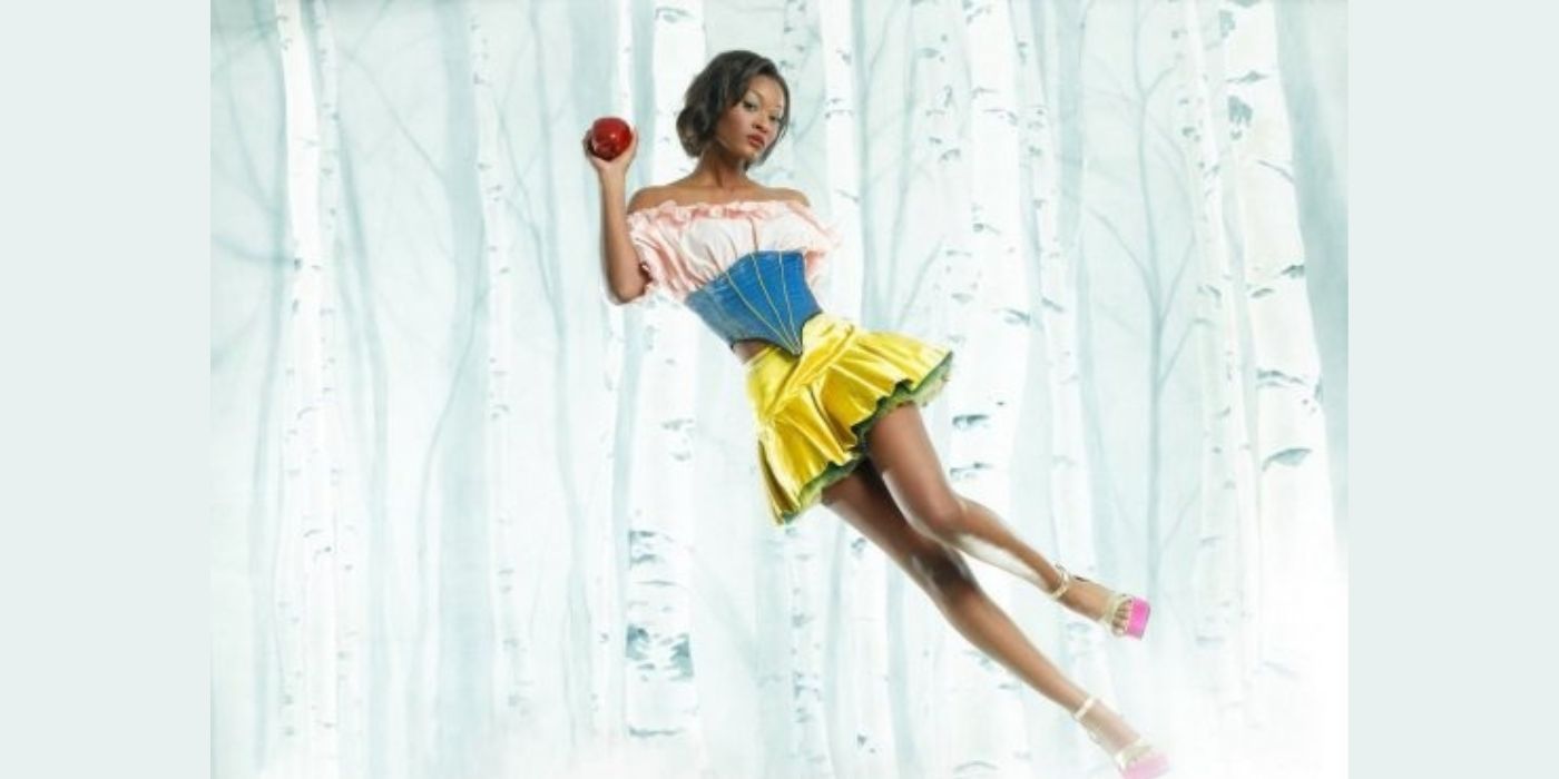 Danielle Evans holds a red apple and is dressed as a stylized version of Snow White on America's Next Top Model.