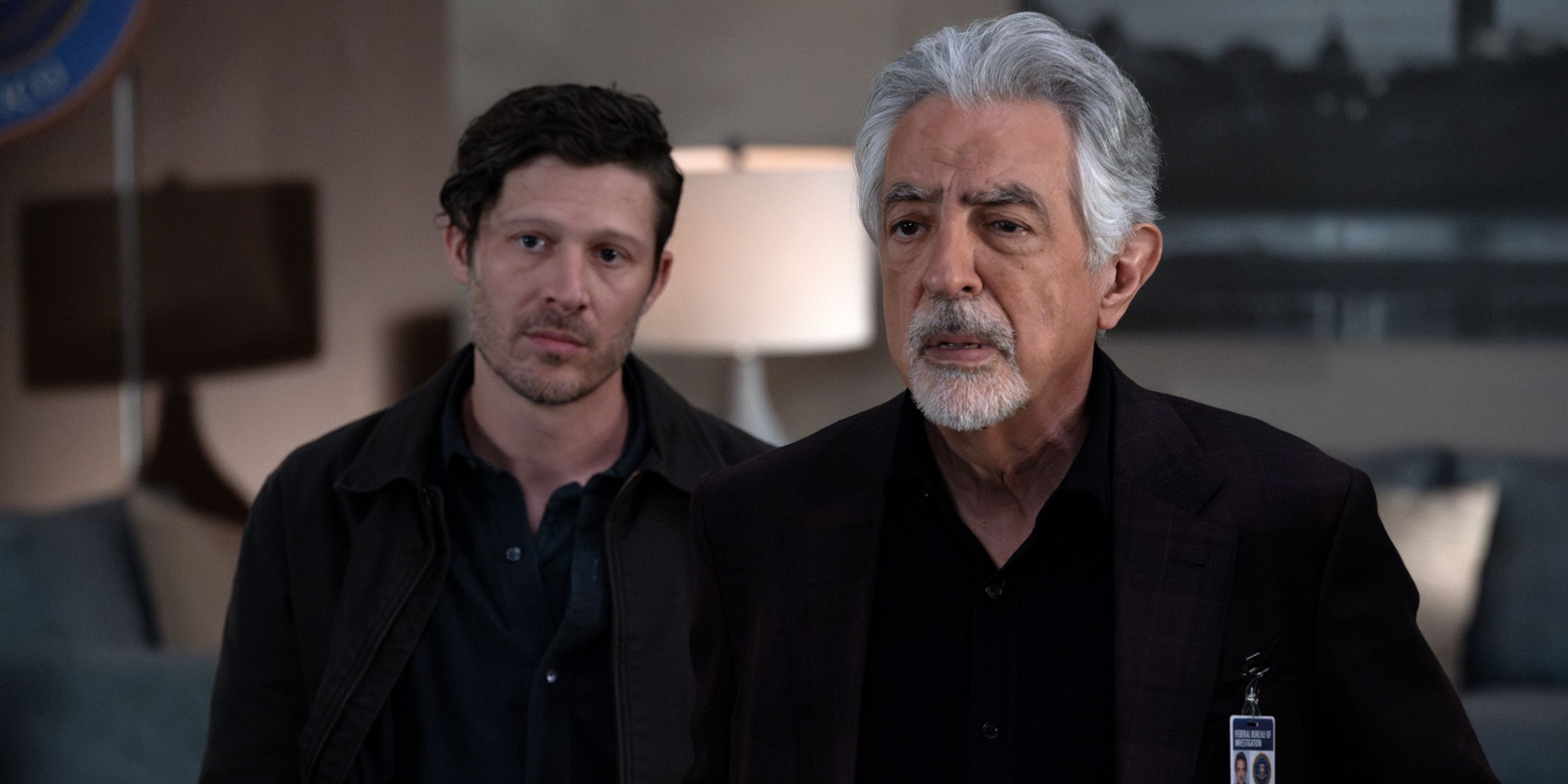 Joe Mantegna as David Rossi and Zach Gilford as Elias Voit standing behind him in Criminal Minds: Evolution