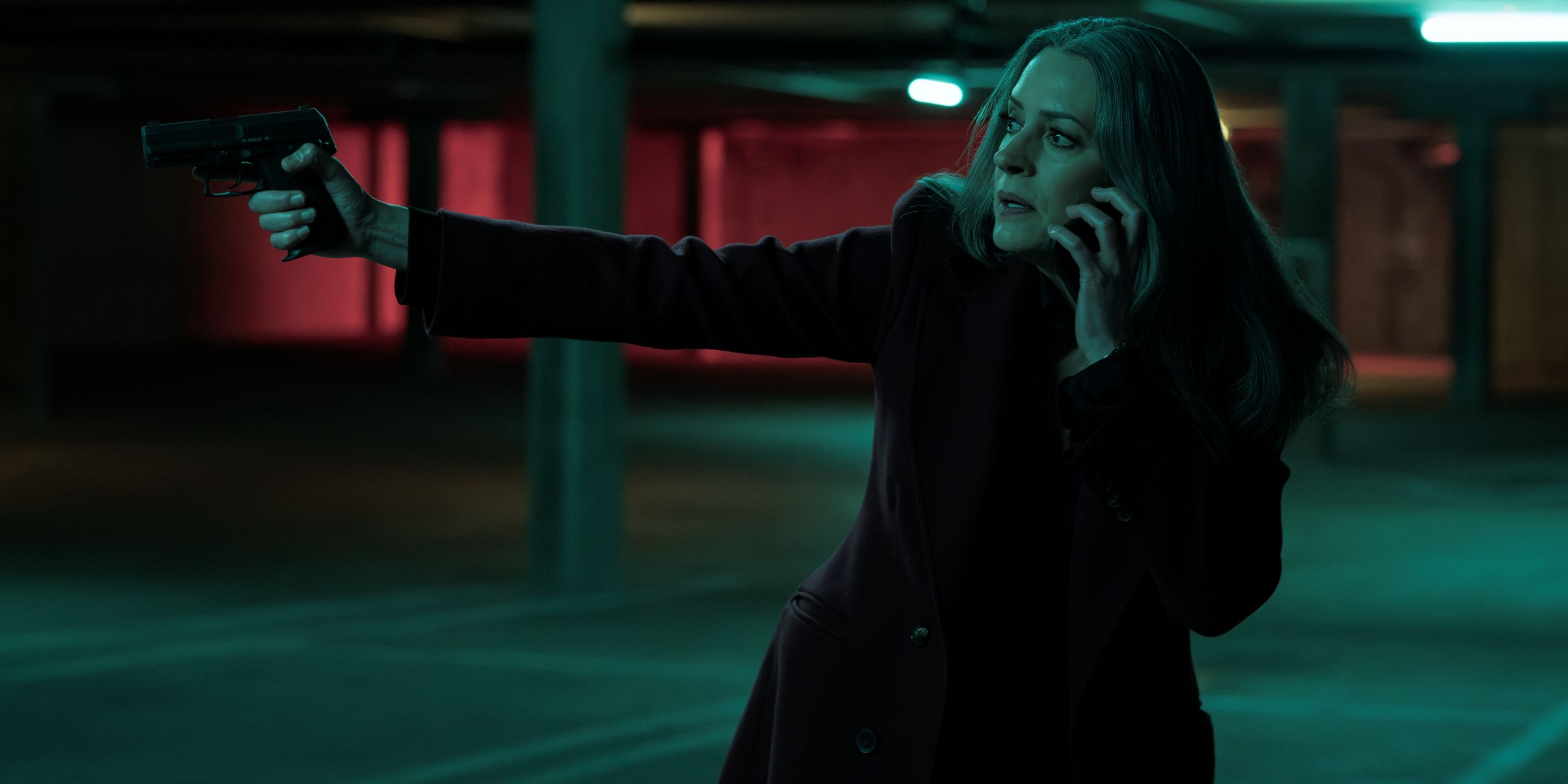 Paget Brewster as Emily Prentiss pointing a gun with her right hand in Criminal Minds: Evolution