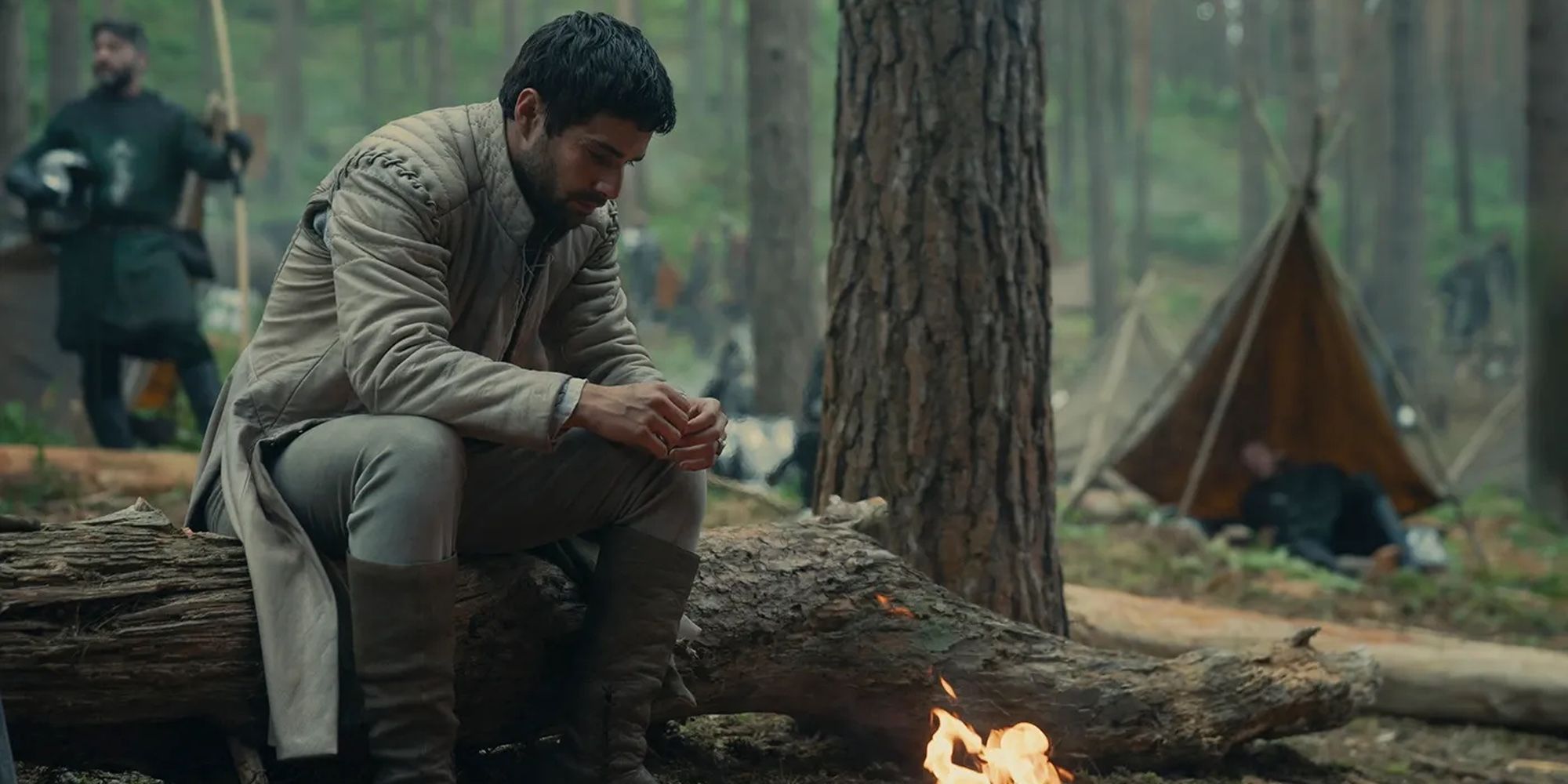 Criston Cole (Fabien Frankel) stares somberly at a fire in the forest in the Season 2 finale of House of the Dragon