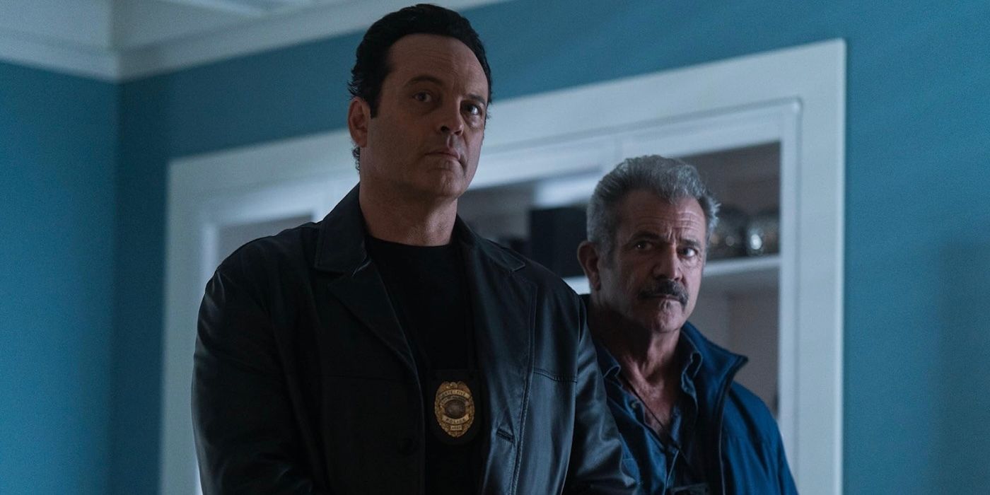 Mel Gibson and Vince Vaughn stand together with police badges on in Dragged Across Concrete.