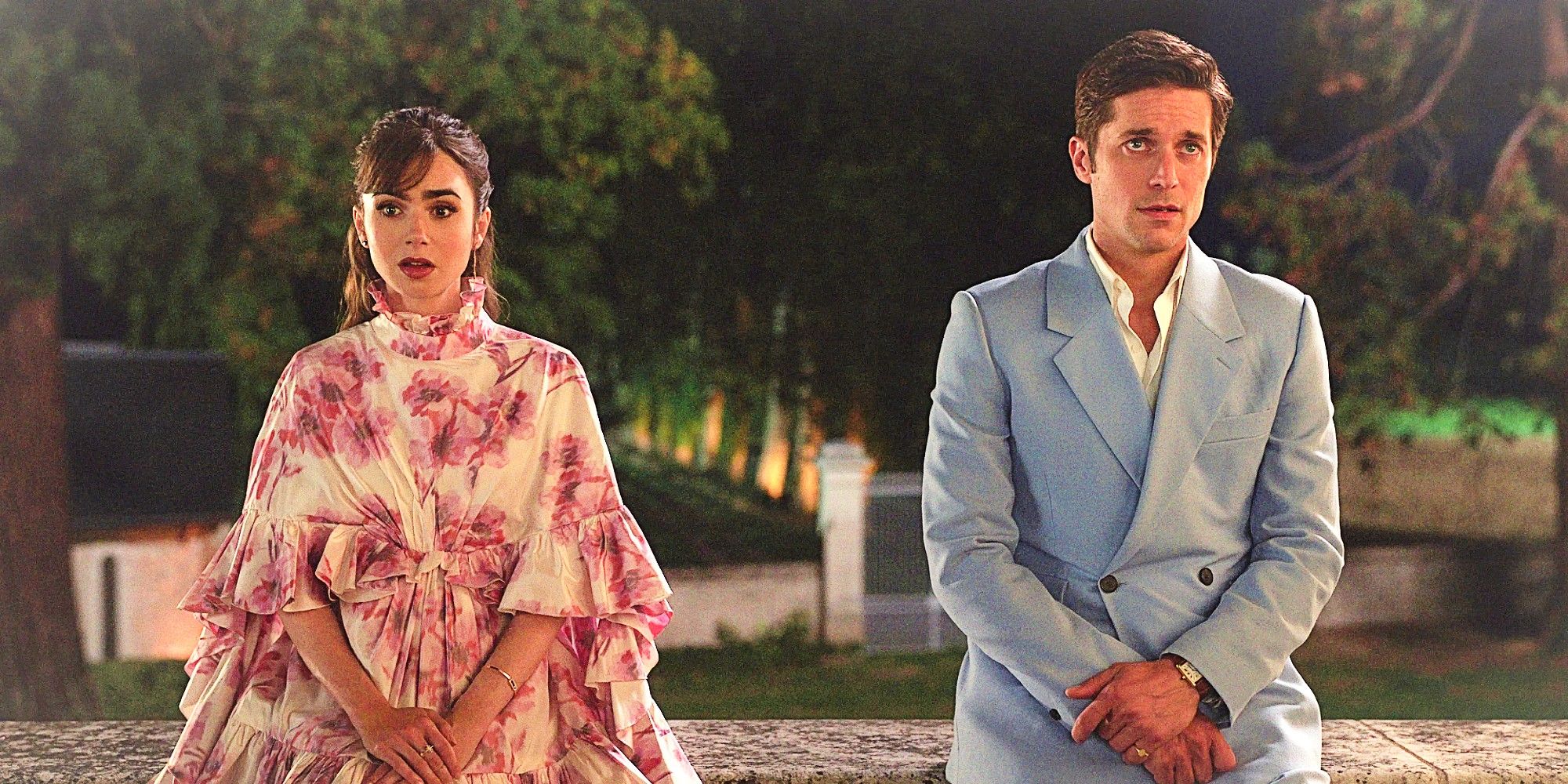 A still from Emily in Paris: Emily and Gabriel sit about a foot apart in evening wear, just after Gabriel tells Emily about Camille's pregnancy. Emily looks speechless and heartbroken; Gabriel looks uncomfortable and guilty.