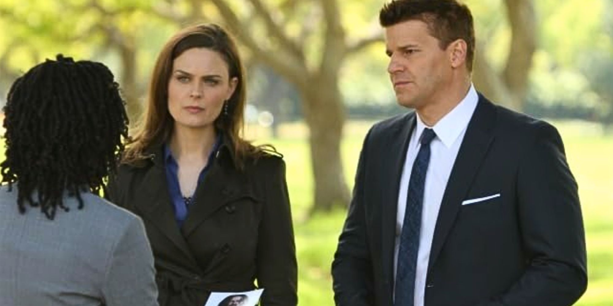 Emily Deschanel as Brennan and David Boreanaz as Booth standing next to each other in Bones