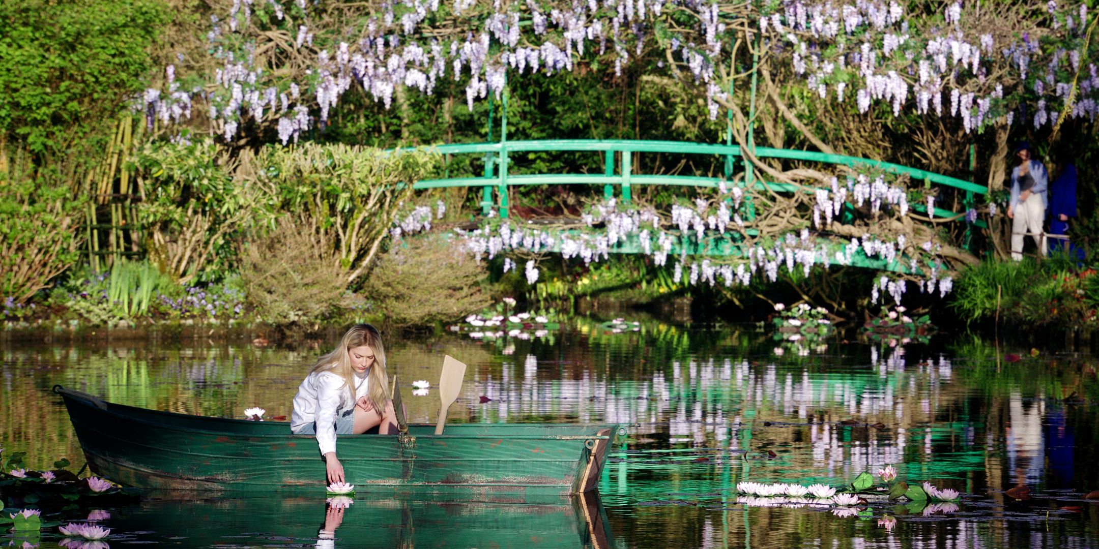 Razat as Camille in Giverny Gardens in Emily in Paris.