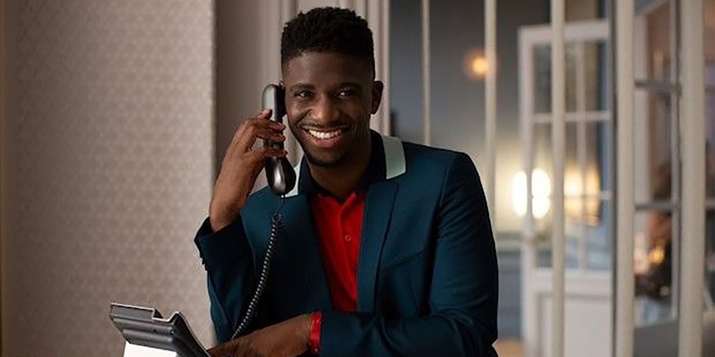 Julien smiling while on the phone in Emily in Paris.