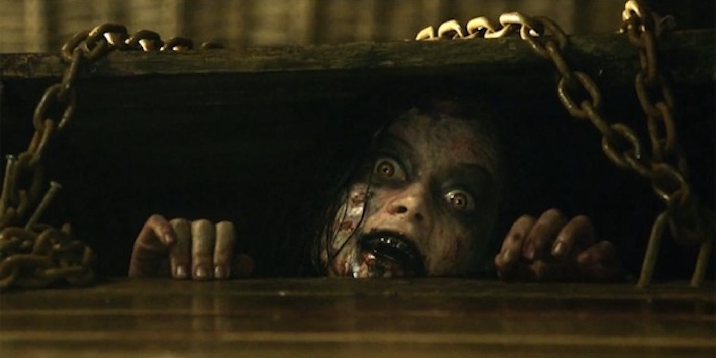Jane Levy as Deadite Mia poking her head out of the basement in Evil Dead 2013