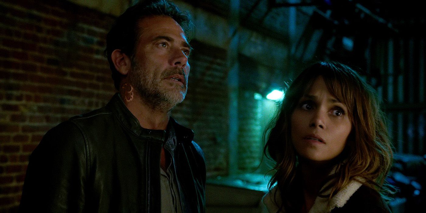 Jeffrey Dean Morgan and Halle Berry in the dark outside looking up at something in Extant.