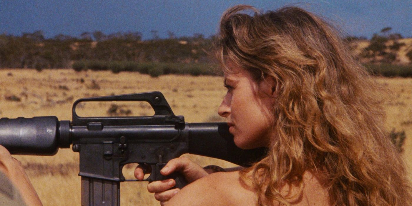 A woman aiming a rifle at someone in Fair Game