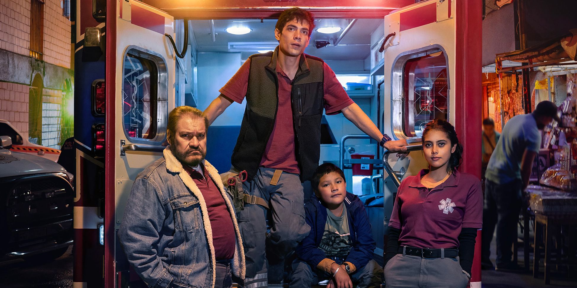 The cast pose outside an ambulance in Familia de Medianoche, also known as Midnight Family