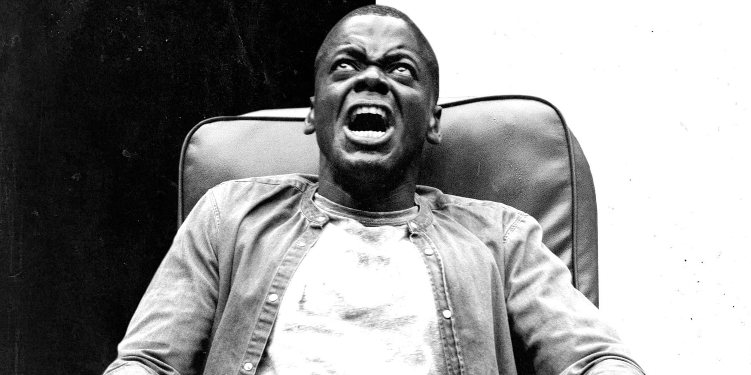 Daniel Kaluuya as Chris sits in a leather armchair screaming on the poster for Get Out