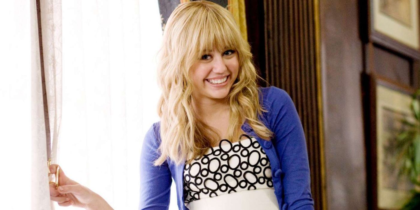 Miley Cyrus as Hannah Montana smiling next to the window in 'Hannah Montana: The Movie'.