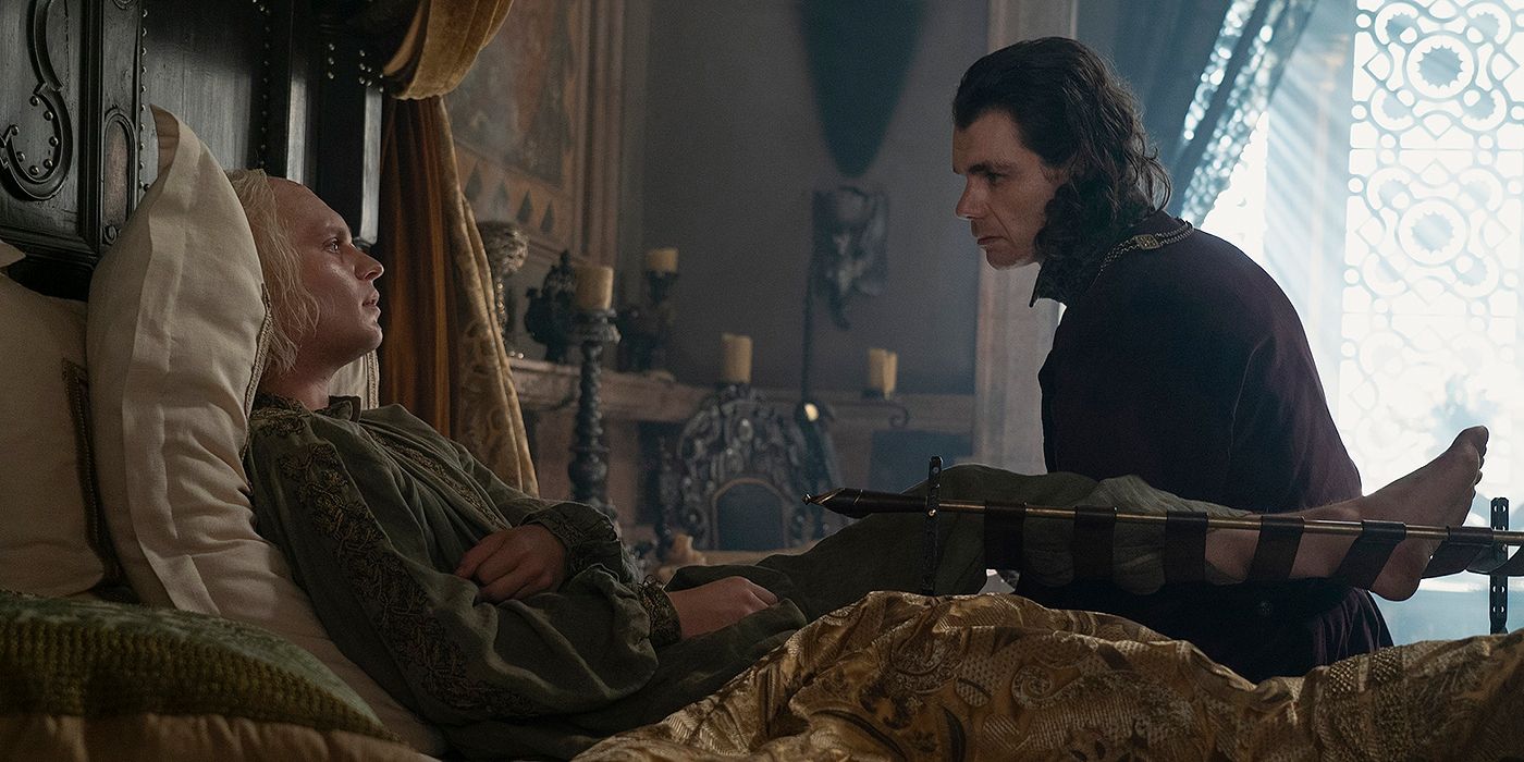 Tom Glynne-Carney as Aegon II in bed and talking to Matthew Needham as Larys in House of the Dragon Season 2 Episode 8