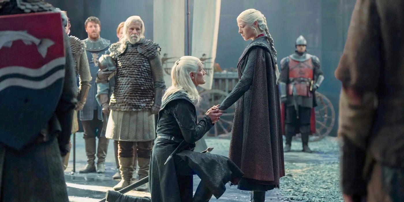 Daemon Targaryen (Matt Smith) kneeling in front of Rhaenyra Targaryen (Emma D'Arcy) and holding her hand in both of his in the House of the Dragon Season 2 finale