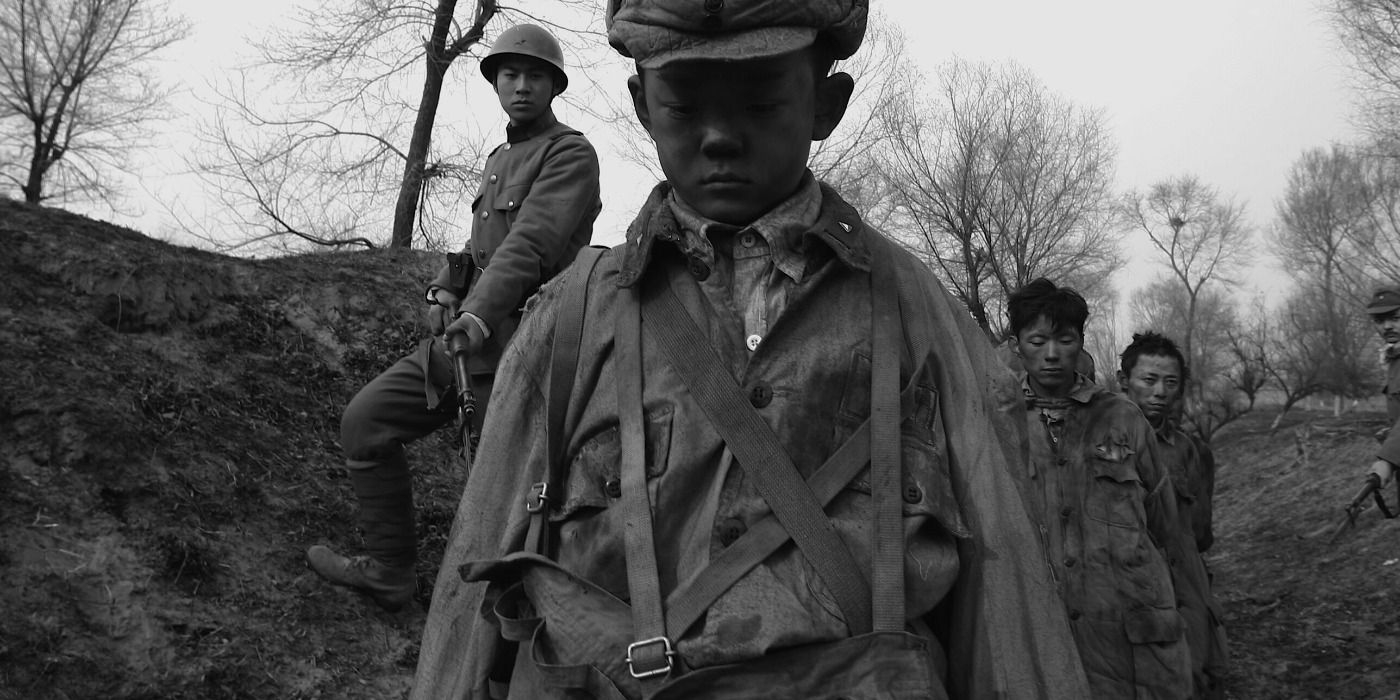 Liu Bin as Ziaodouzi being marched by a Japenese soldier in City of Life and Death