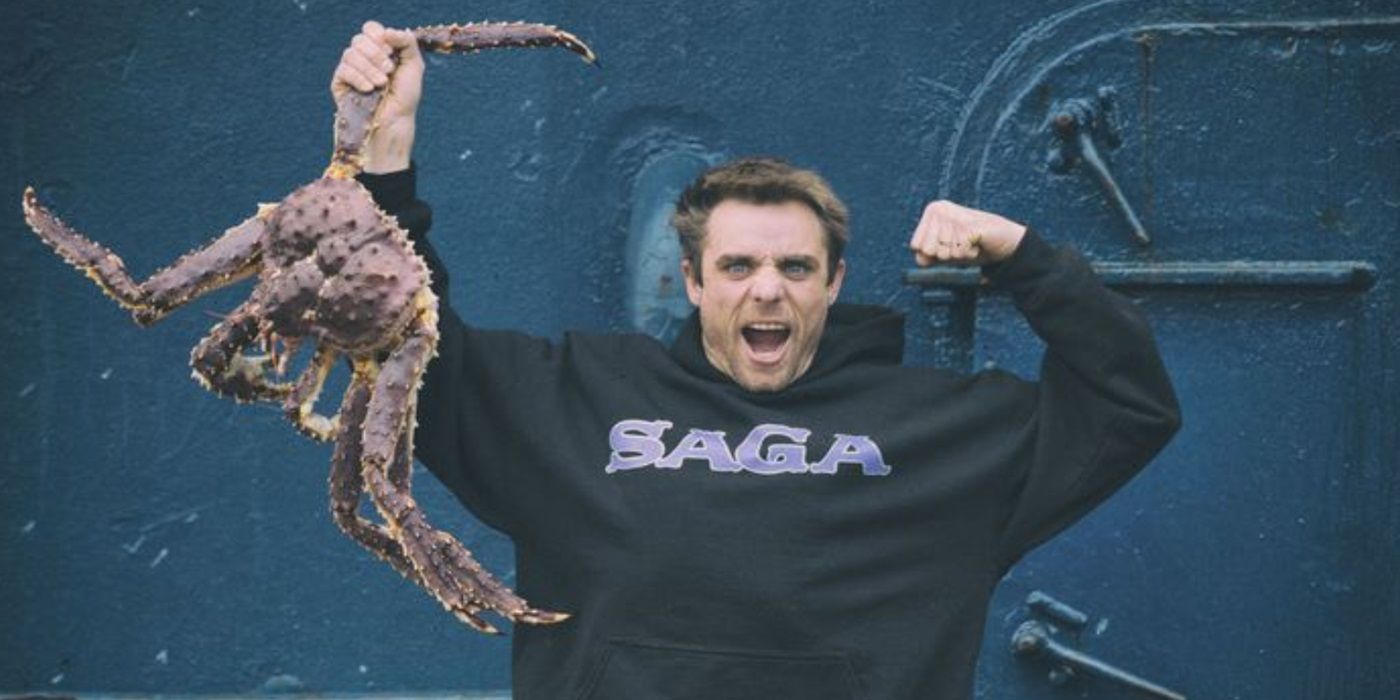 Jake Anderson holding a king crab proudly in Deadliest Catch