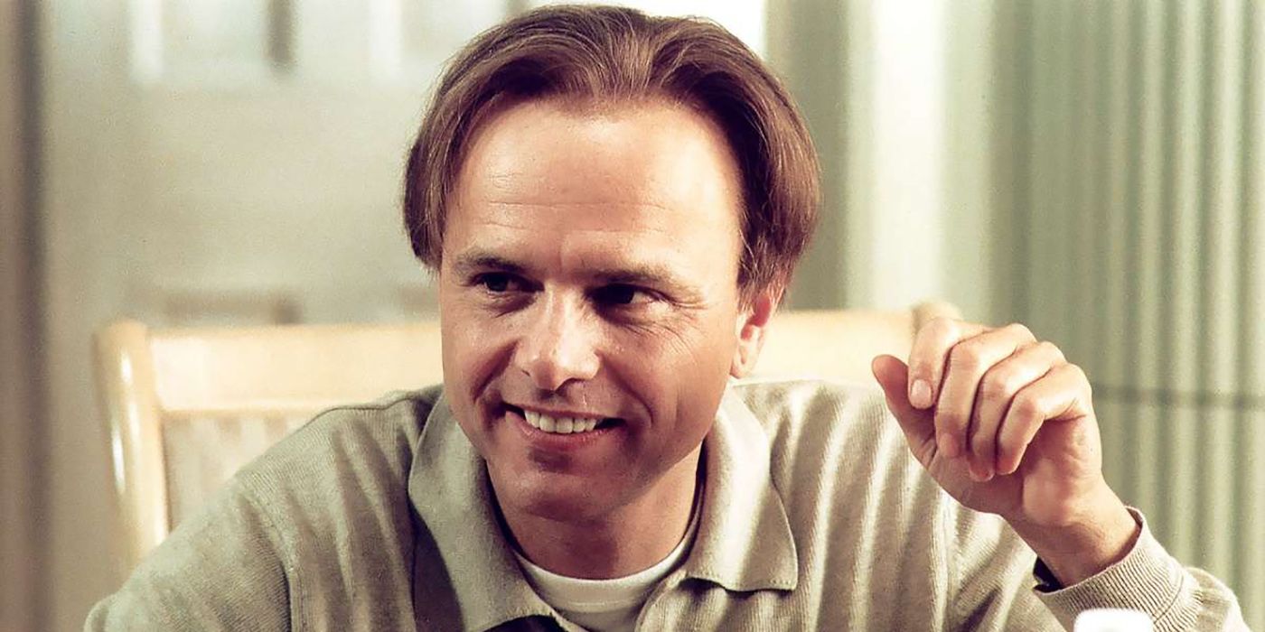 Joe Pantoliano sitting at a table smiling in The Sopranos