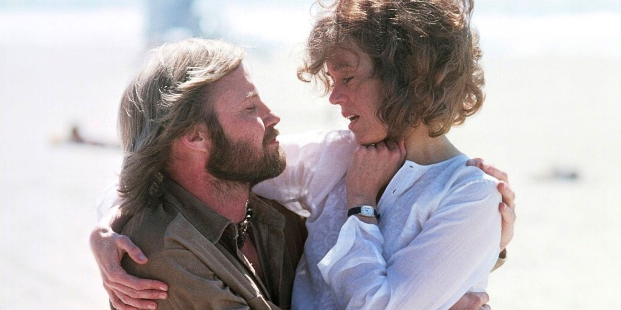 Jon Voight looking at Jane Fonda who is sitting on his lap in Coming Home (1978)