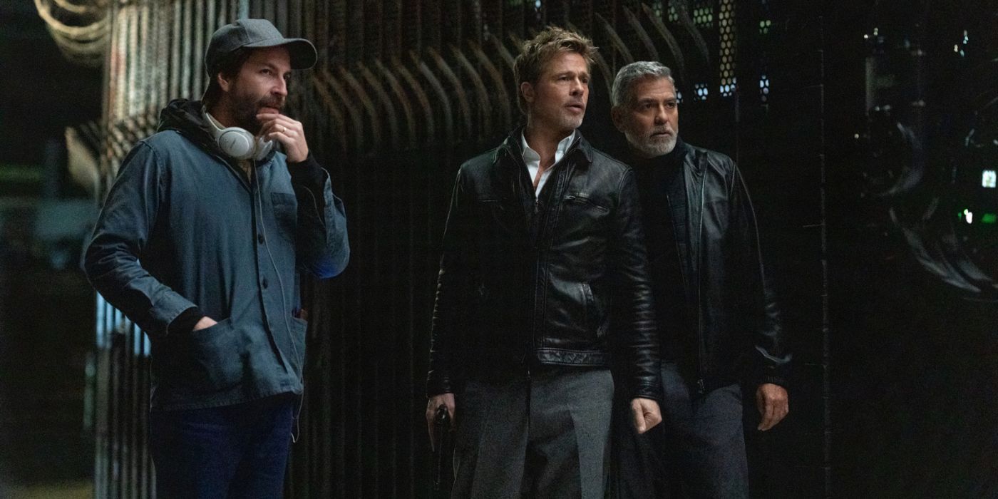 Jon Watts standing next to Brad Pitt and George Clooney on the set of Wolfs.