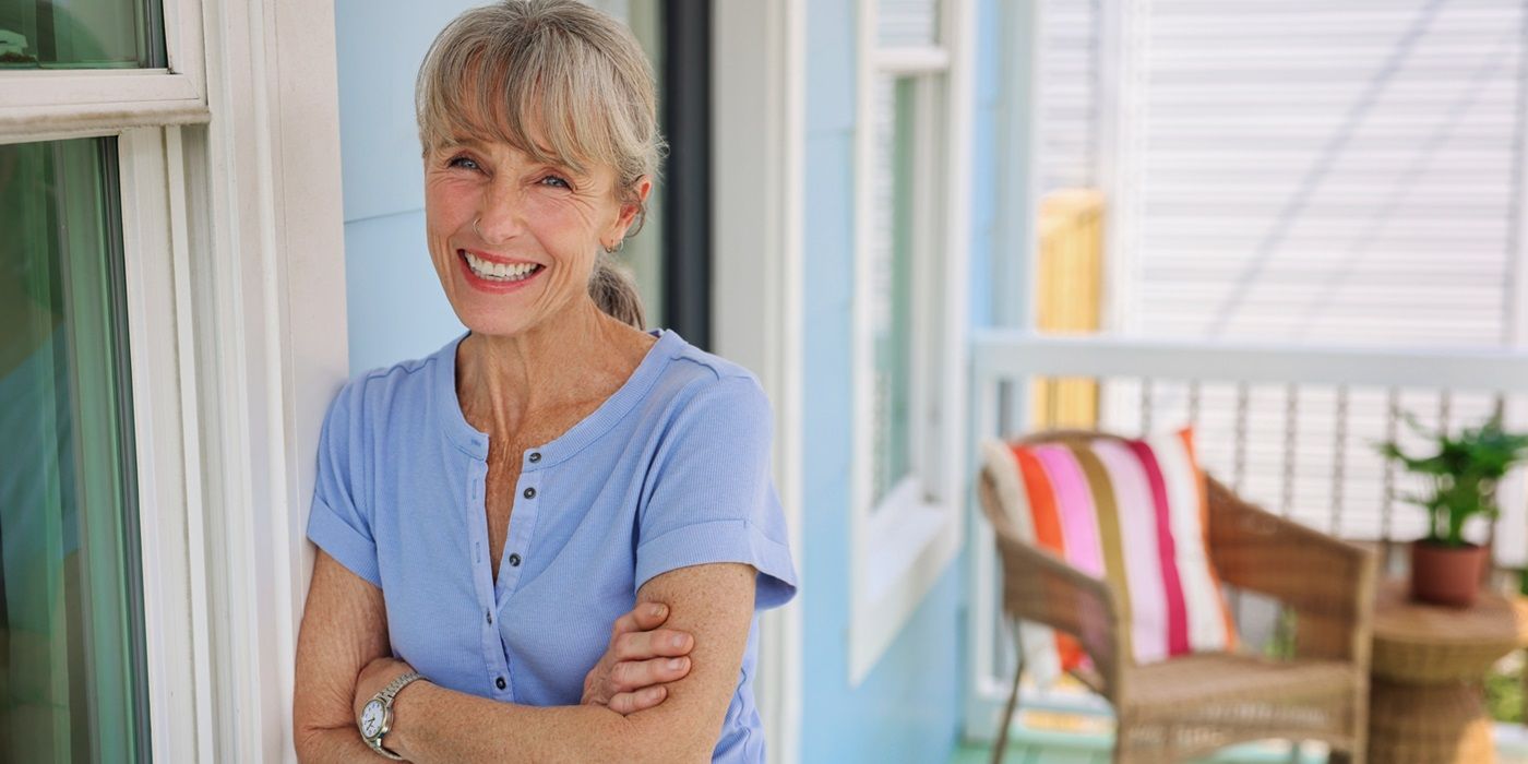 Karen E. Laine smiling with her arms crossed for a profile shot for Good Bones: New Beginnings