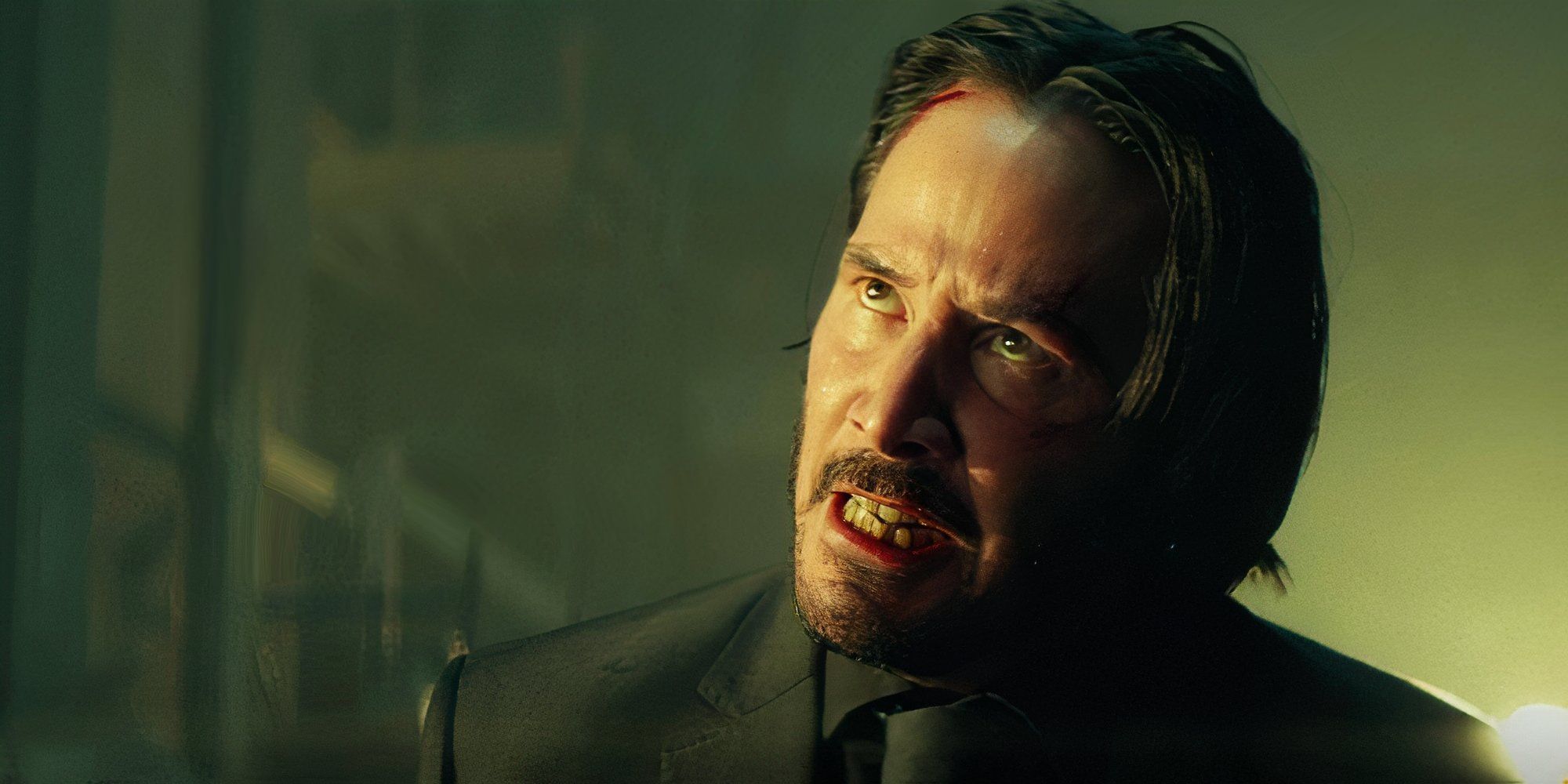 John Wick in the movie John Wick looking upset with a wound on his forehead and blood in his mouth.