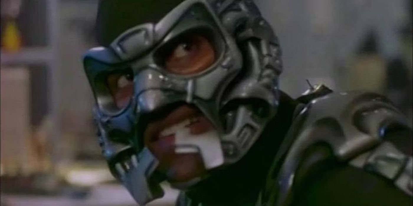 The Mantis (Carl Lumbly) in full costume looks over his shoulder for a threat