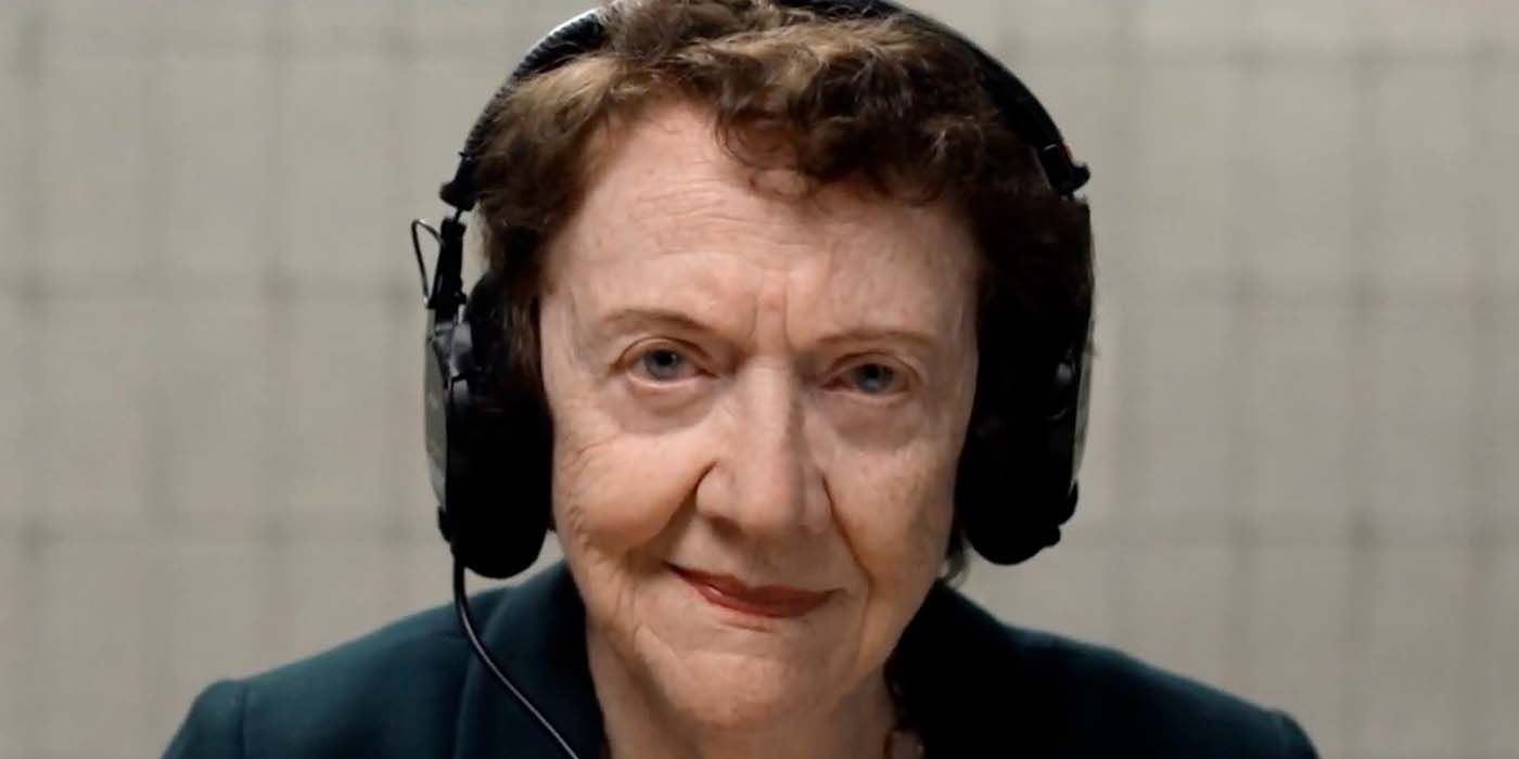 A close up of Ann Burgess from Mastermind: To Think Like a Killer wearing headphones and looking right into the camera.