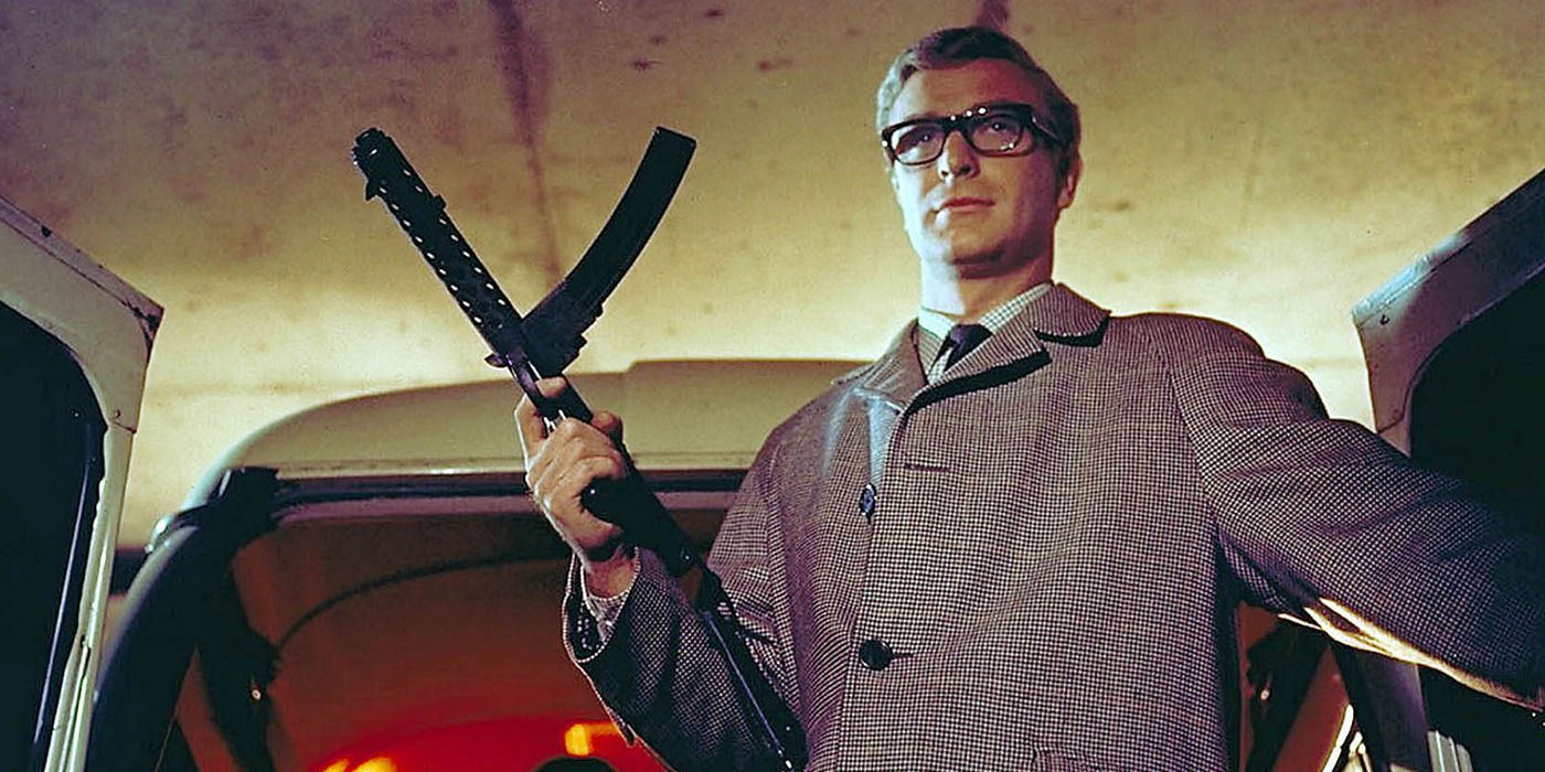 Michael Caine holding a machine gun in 