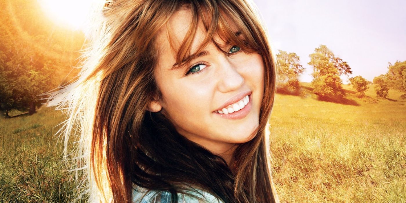 A cover sH๏τ of Miley Cyrus smiling with her hair blowing in the wind in 'Hannah Montana: The Movie'.