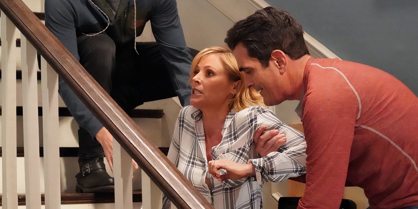 Claire fallen down on the stairs in Modern Family as Phil tries to help her up.