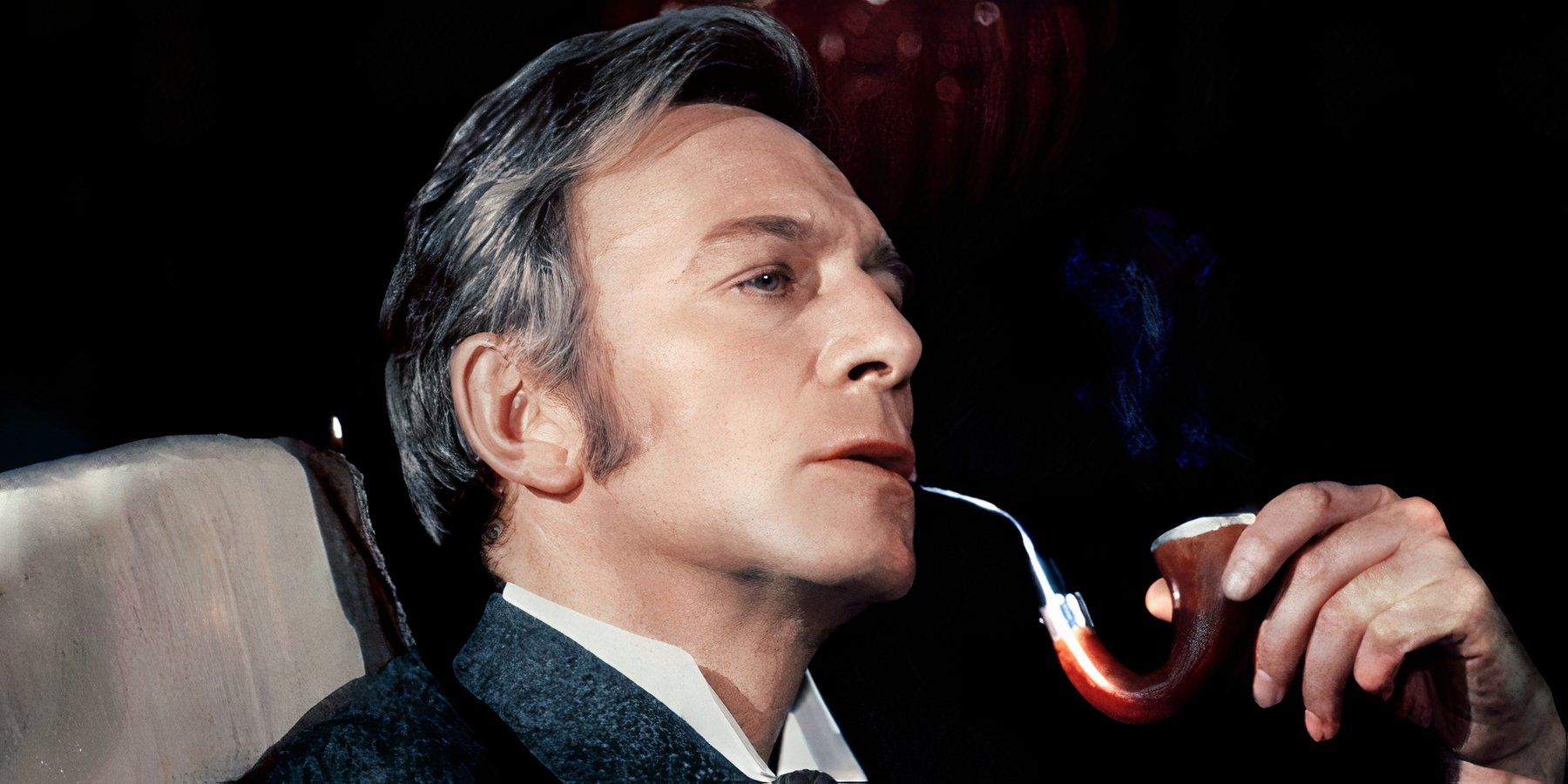 Christopher Plummer as Sherlock Holmes smoking his pipe and looking pensive in Murder by Decree.