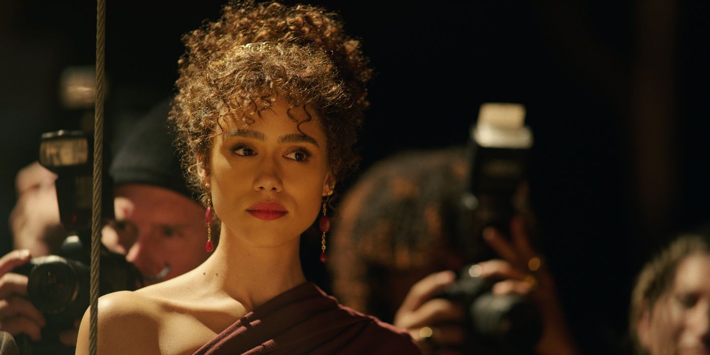 Nathalie Emmanuel surrounded by photographers in Megalopolis.