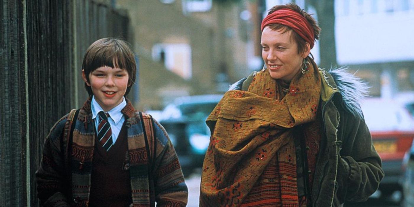 Toni Collette as Fiona and Nicholas Hoult as Marcus walking in the street in About A Boy