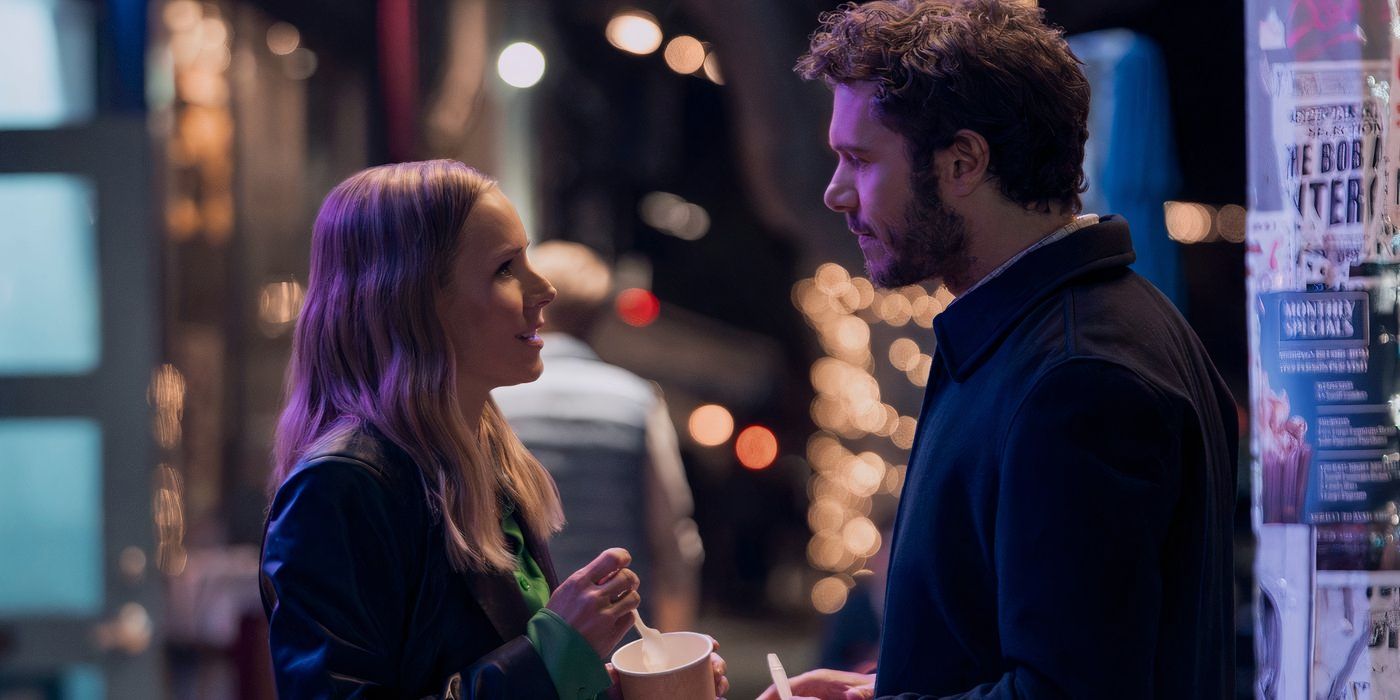 kristen bell and adam brody stand opposite one another outside eating ice cream