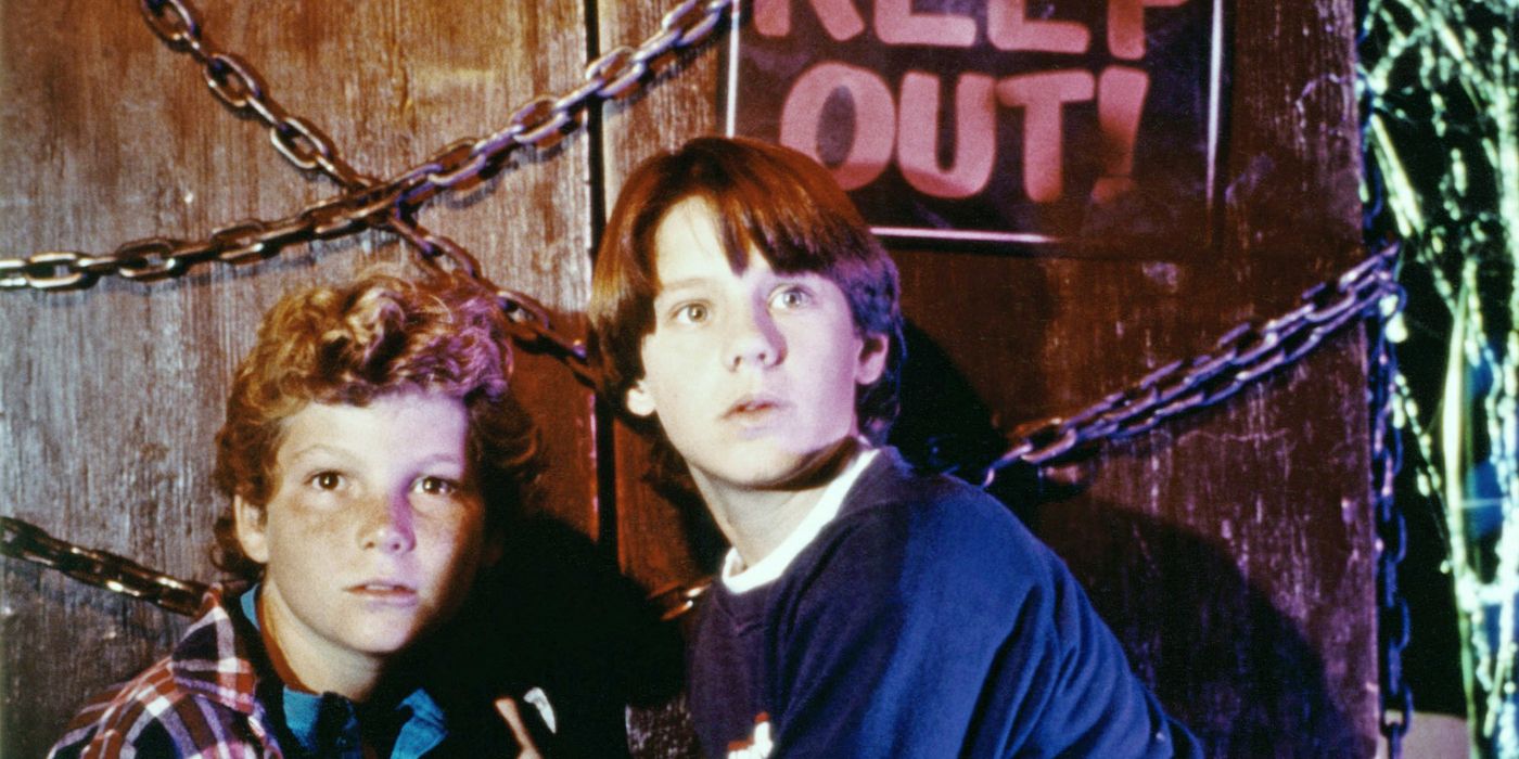 Omri Katz and Justin Shenkarow in front of a Keep Out sign and chains in Eerie, Indiana