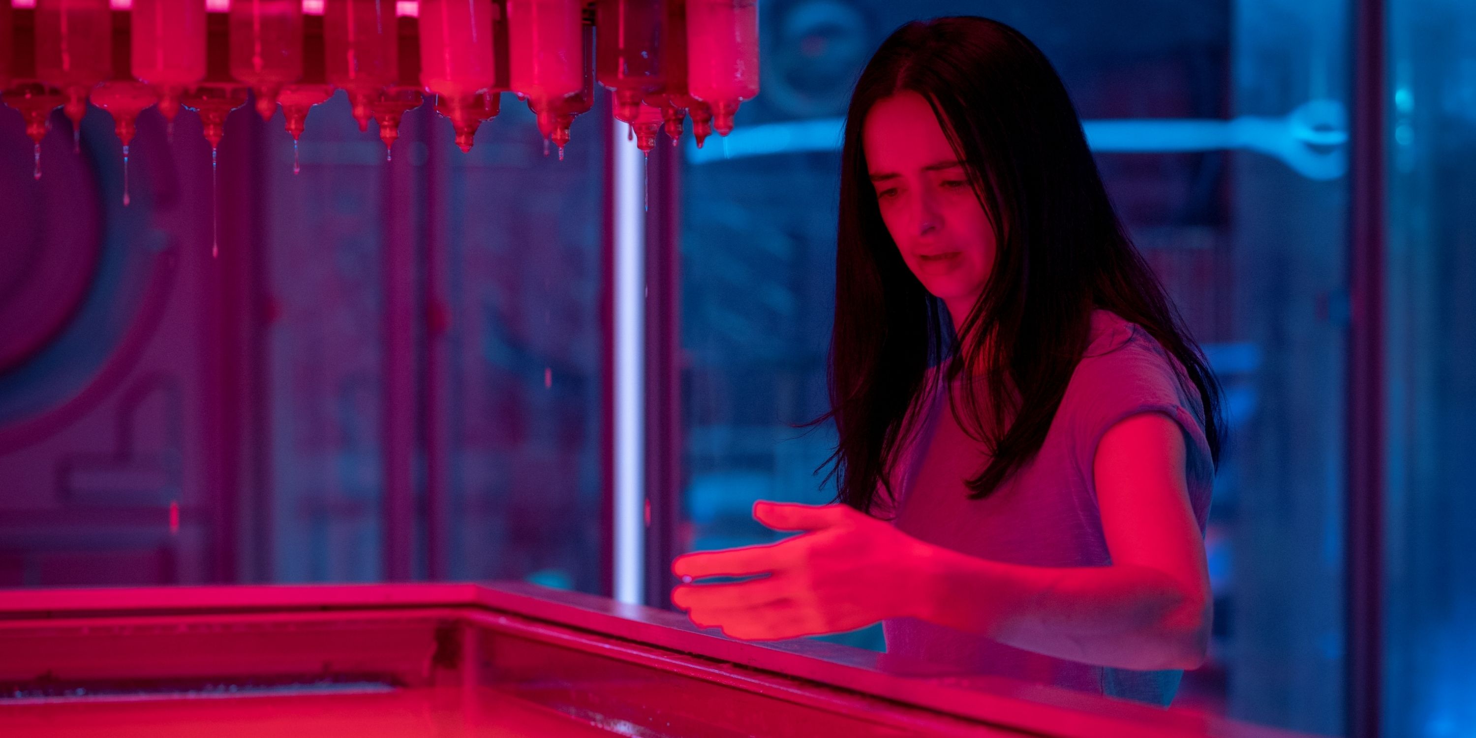 Krysten Ritter as Lucy standing over the vat of pink goo in Orphan Black: Echoes