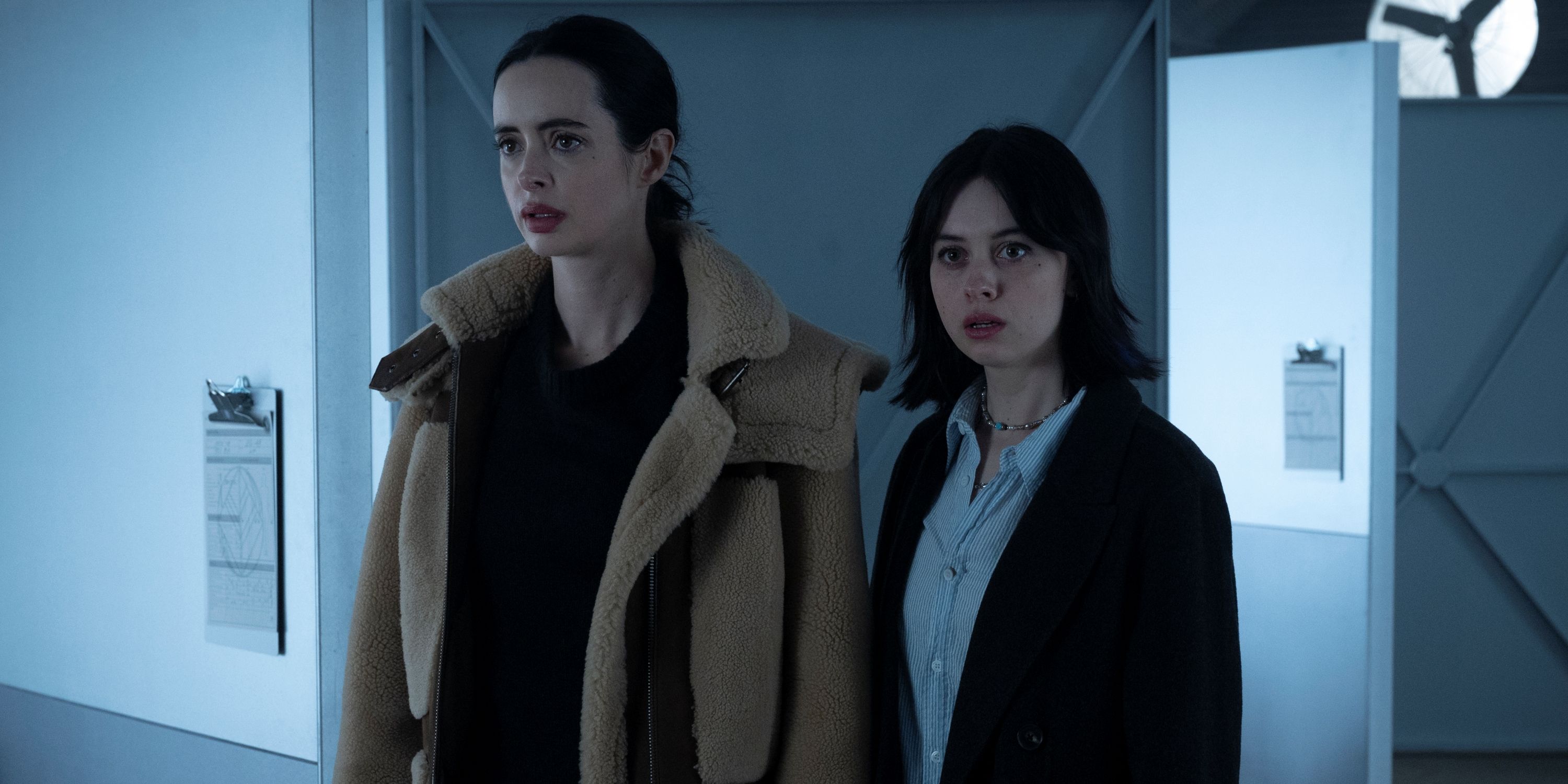 Krysten Ritter as Lucy standing with Amanda Fix as Jules as they look forward in Orphan Black: Echoes