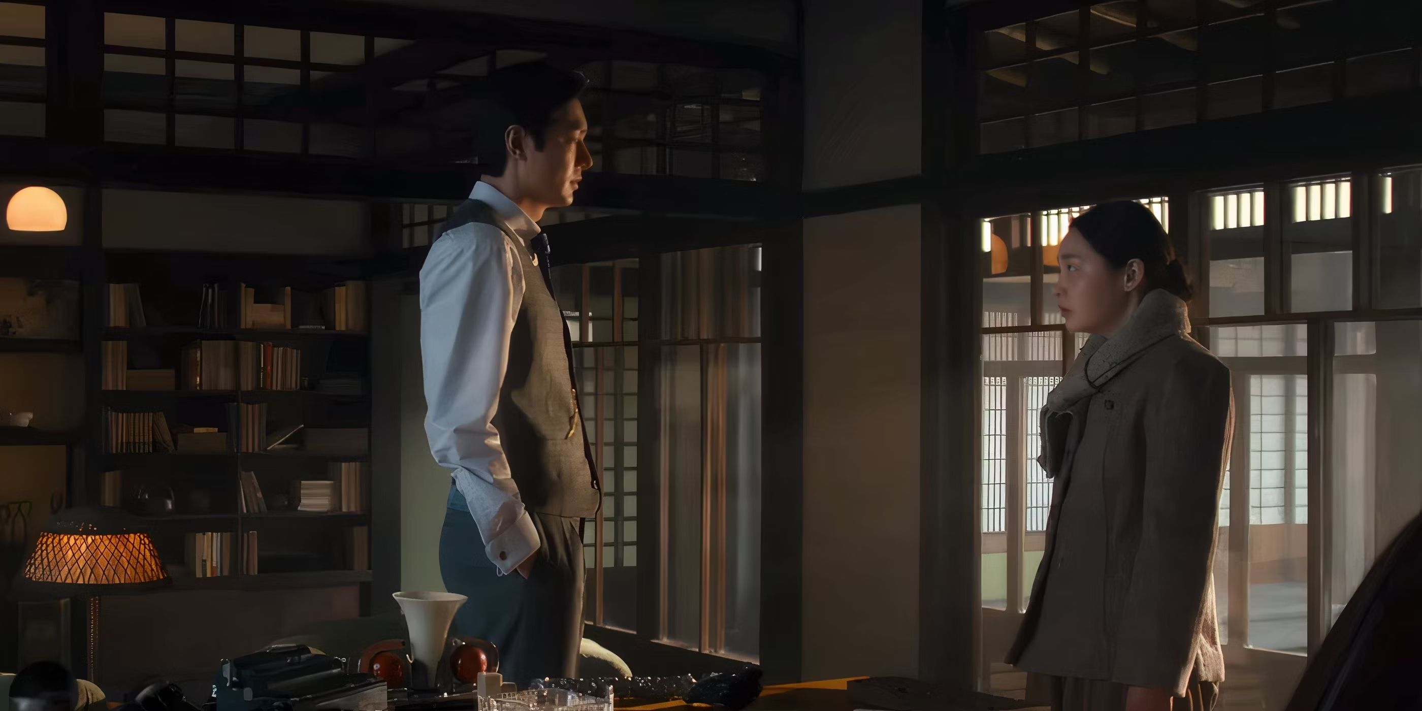 Hansu stands next to Sunja in a home library in a scene from Season 2, Episode 1 of &lsquo;Pachinko.'