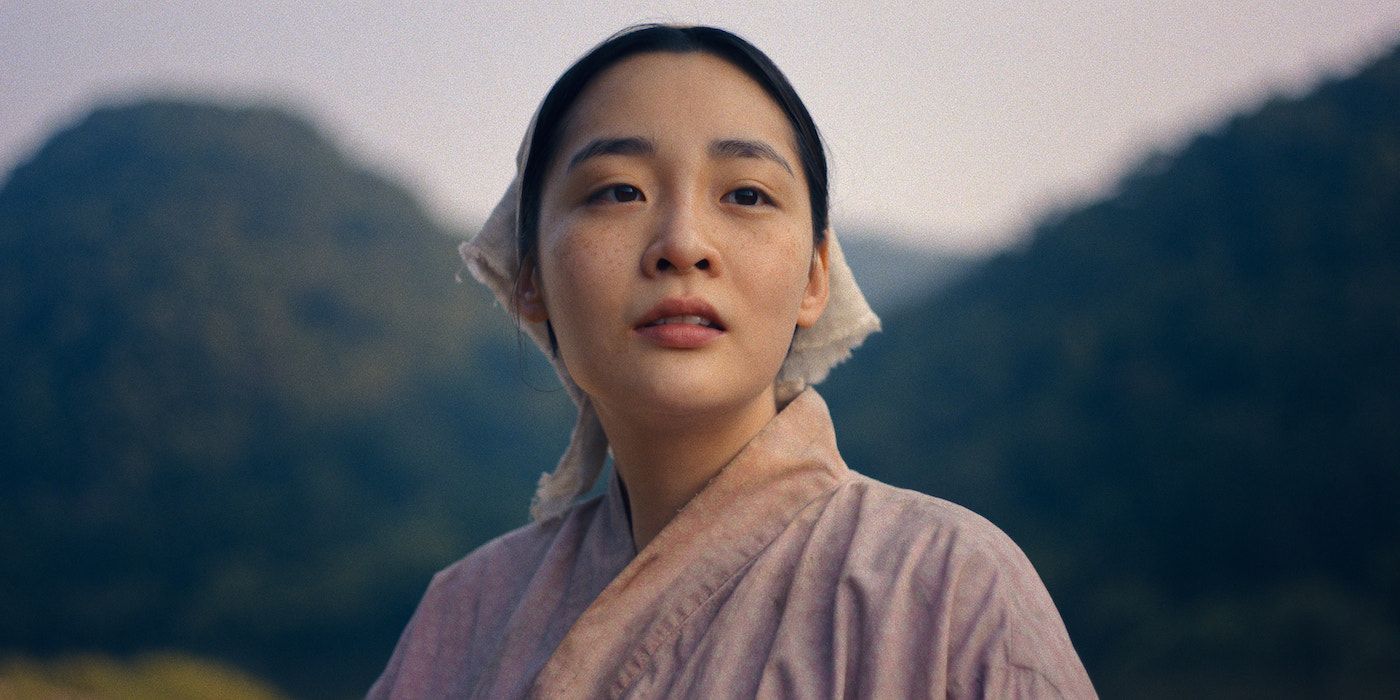 Kim Min-ha as young Sunja looking out on the world in a still from Pachinko Season 2. 