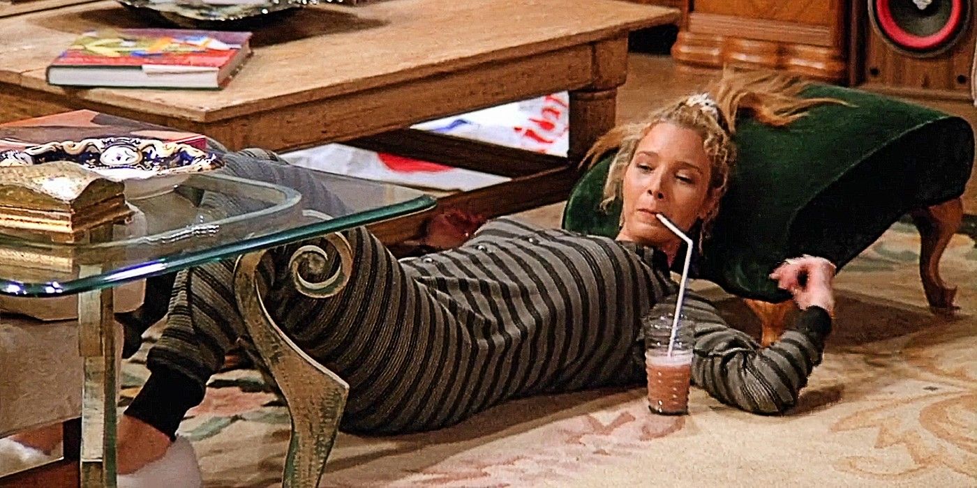 Phoebe laying down on the floor drinking from a straw in Friends Season 1